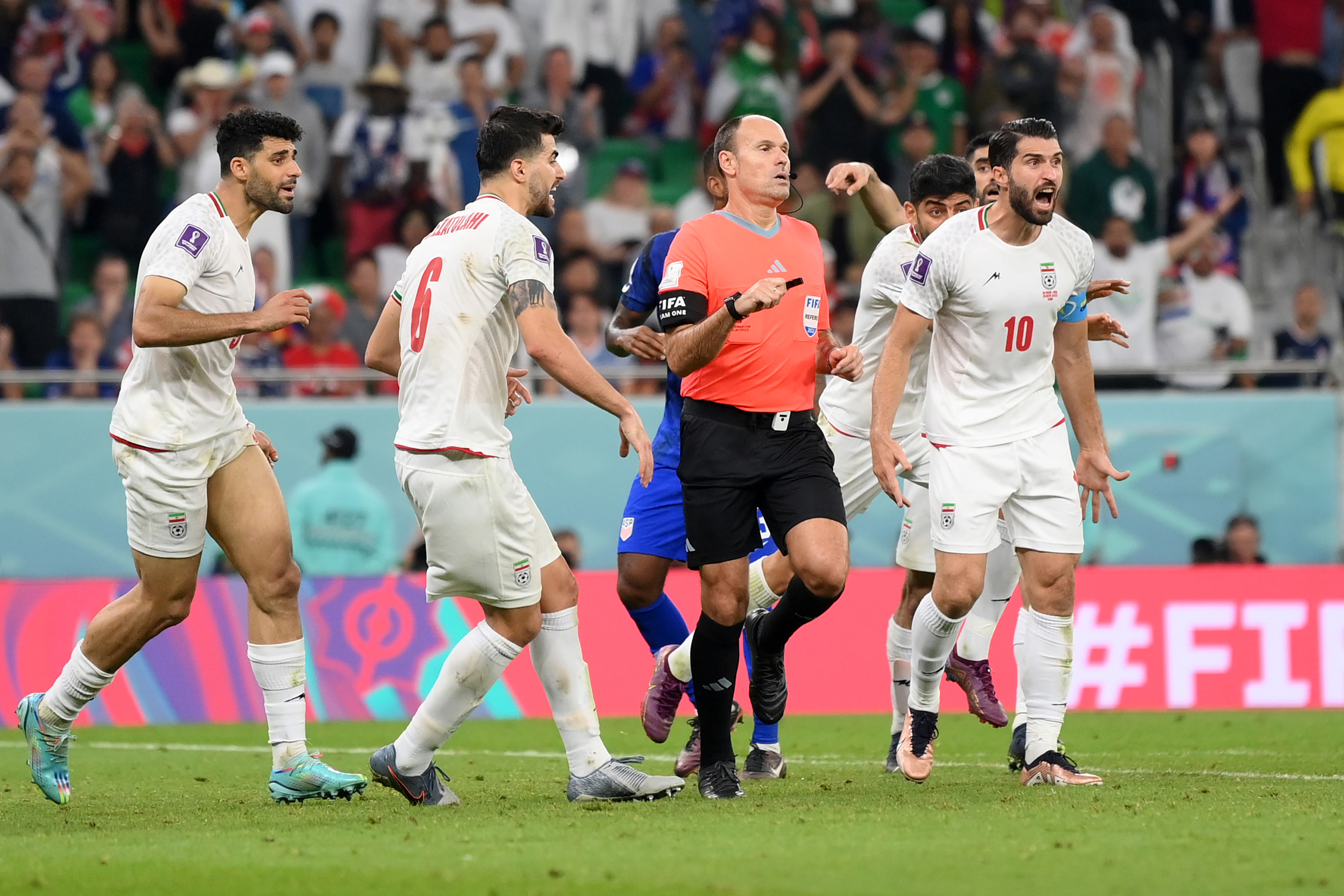 DOHA, QATAR - NOVEMBER 29: IR Iran players argue a call with referee Antonio Miguel Mateu Lahoz during the FIFA World Cup Qatar 2022 Group B match between IR Iran and USA at Al Thumama Stadium on November 29, 2022 in Doha, Qatar. (Photo by David Ramos - FIFA/FIFA via Getty Images)