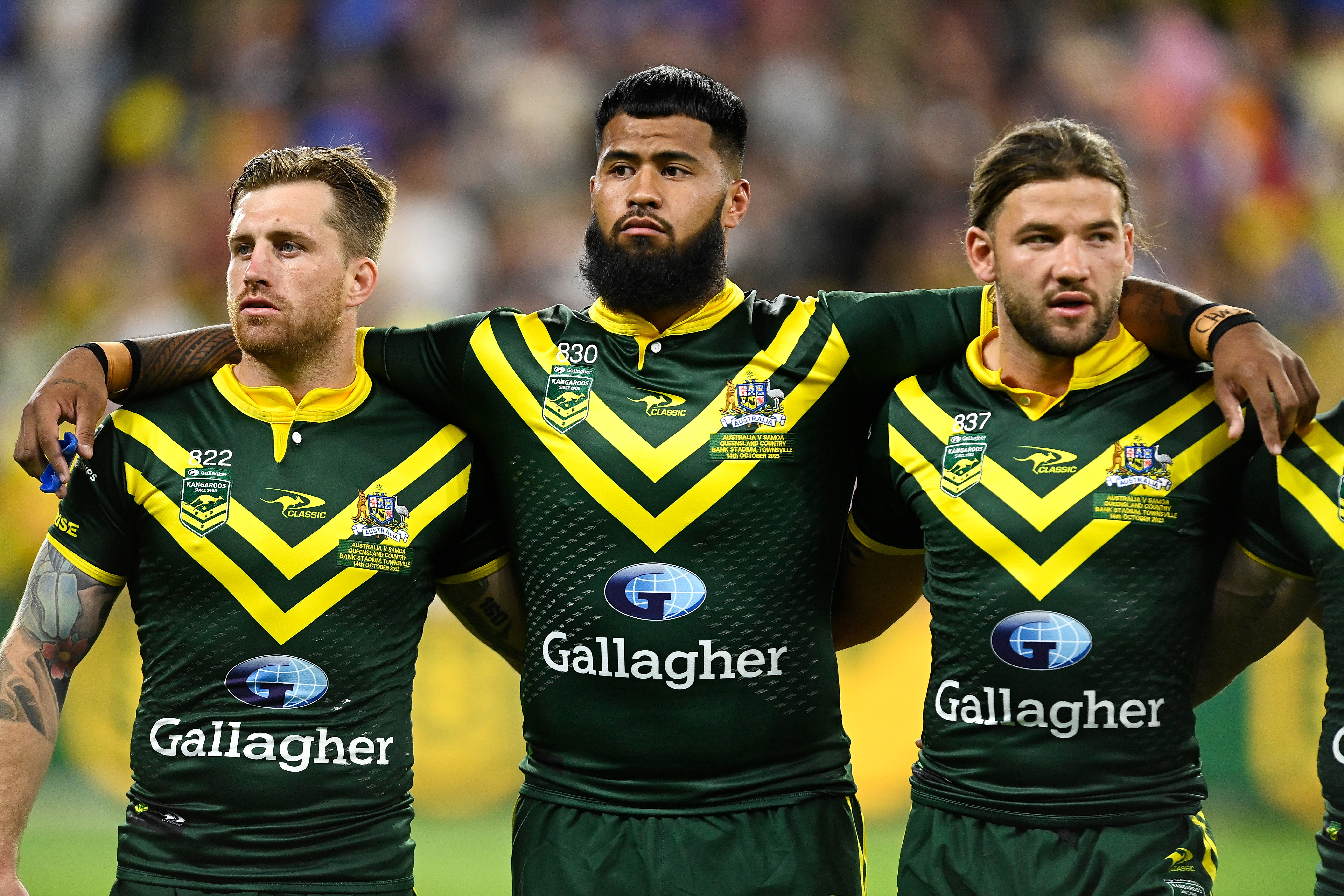 Kangaroos players Cameron Munster, Payne Haas, and Patrick Carrigan during the national anthem.