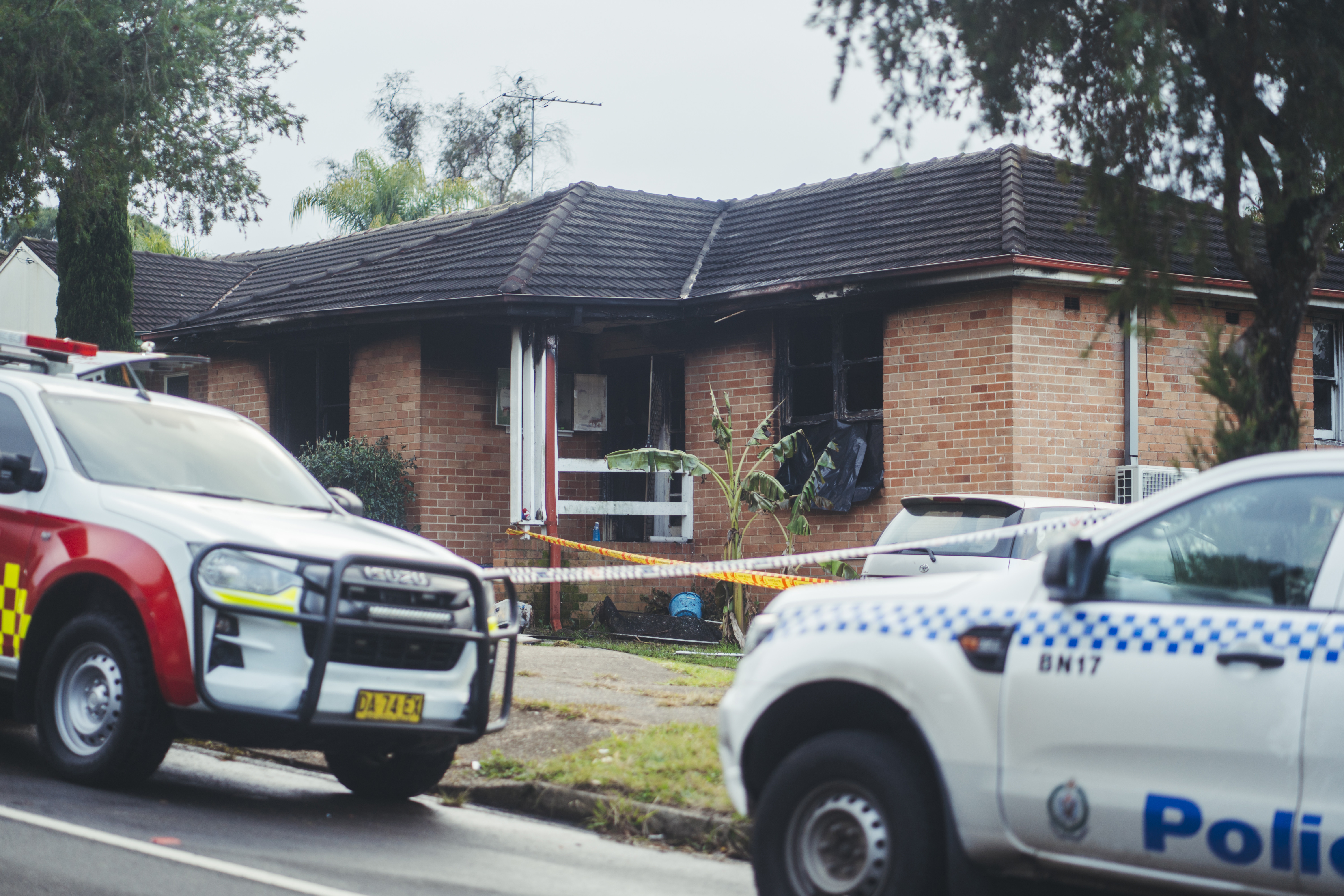 Three children have died and a man is in police custody after a house fire in Lalor Park.