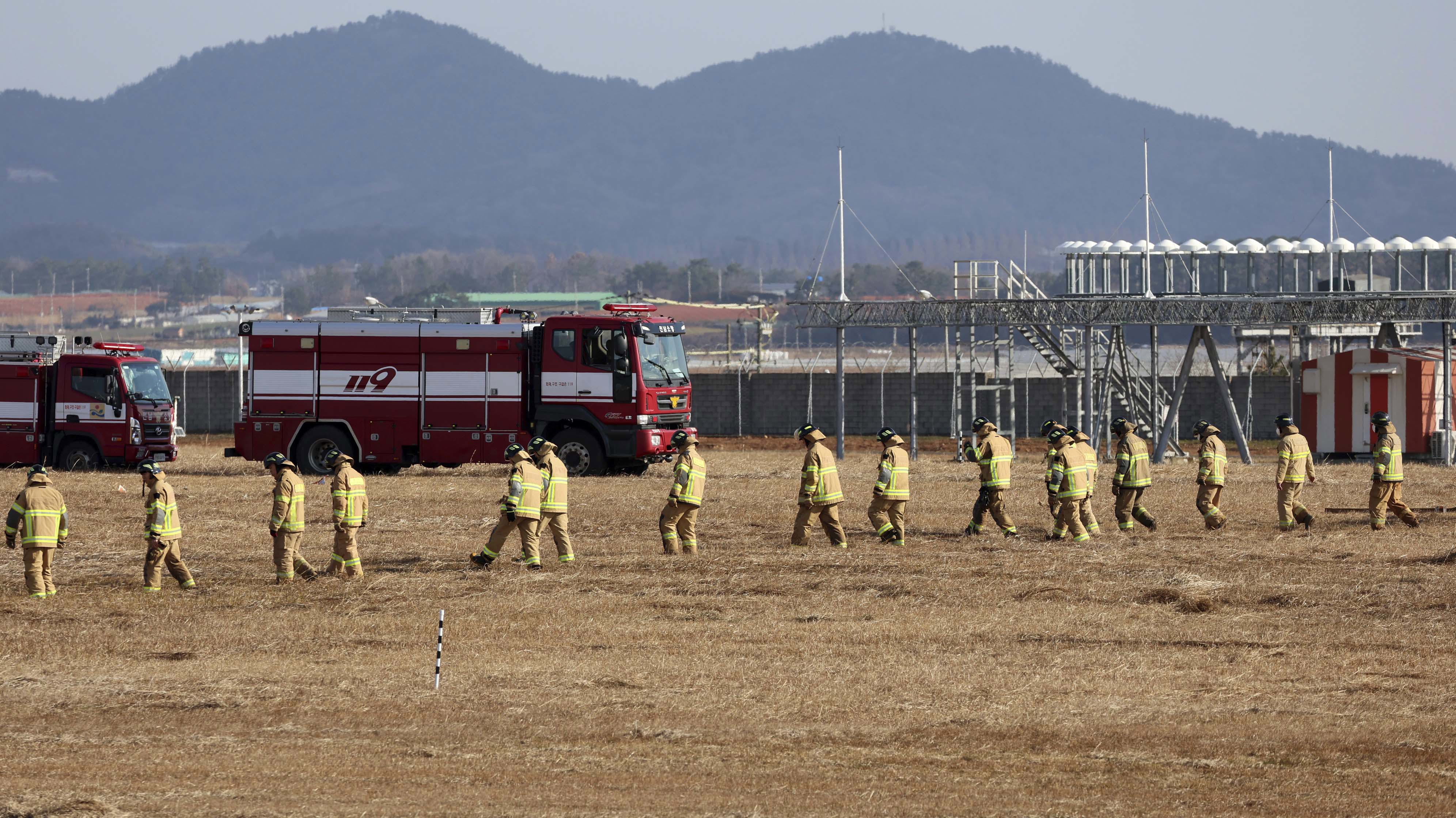 Firefighters and rescue team members work at Muan International Airport in Muan, South Korea,