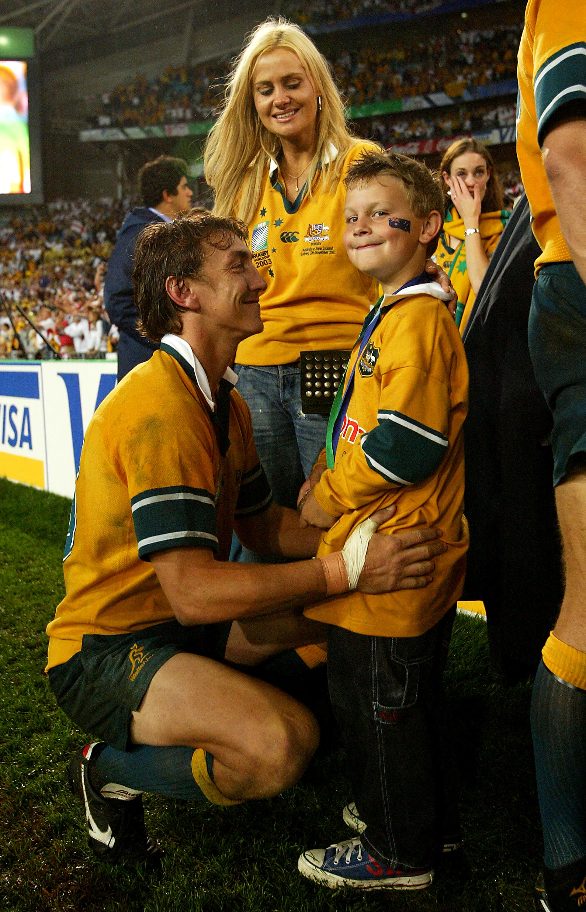 Mat Rogers of the Wallabies with his son and wife after the 2003 Rugby World Cup final.