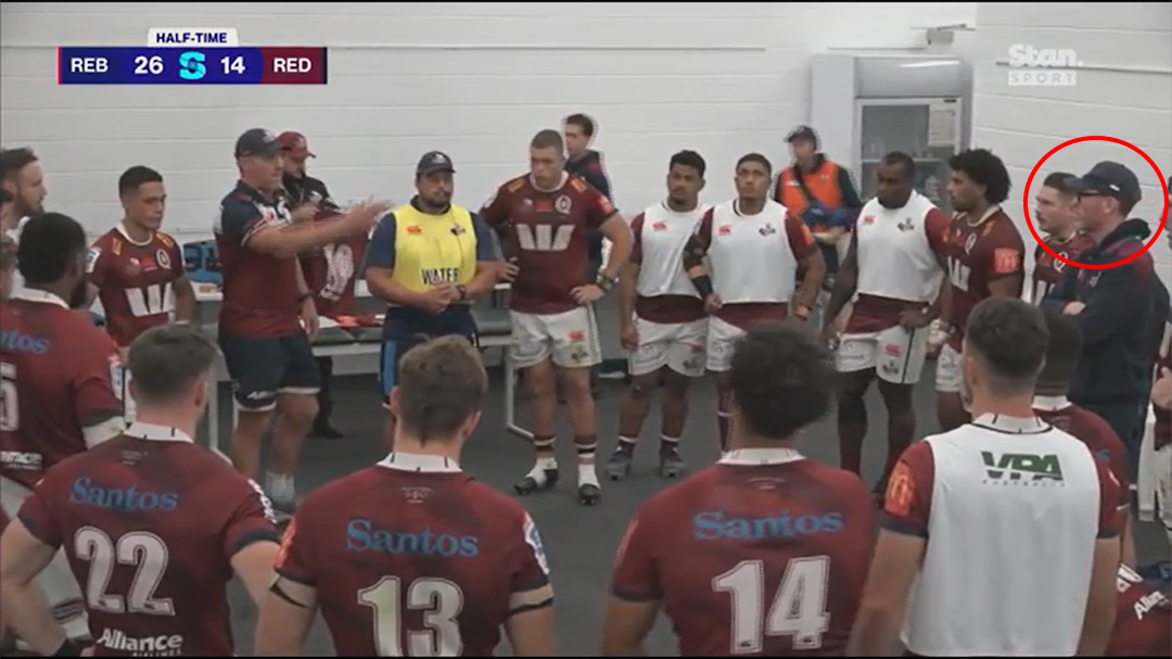 Reds assistant coach Mick Heenan watches Brad Thorn talk to the players.