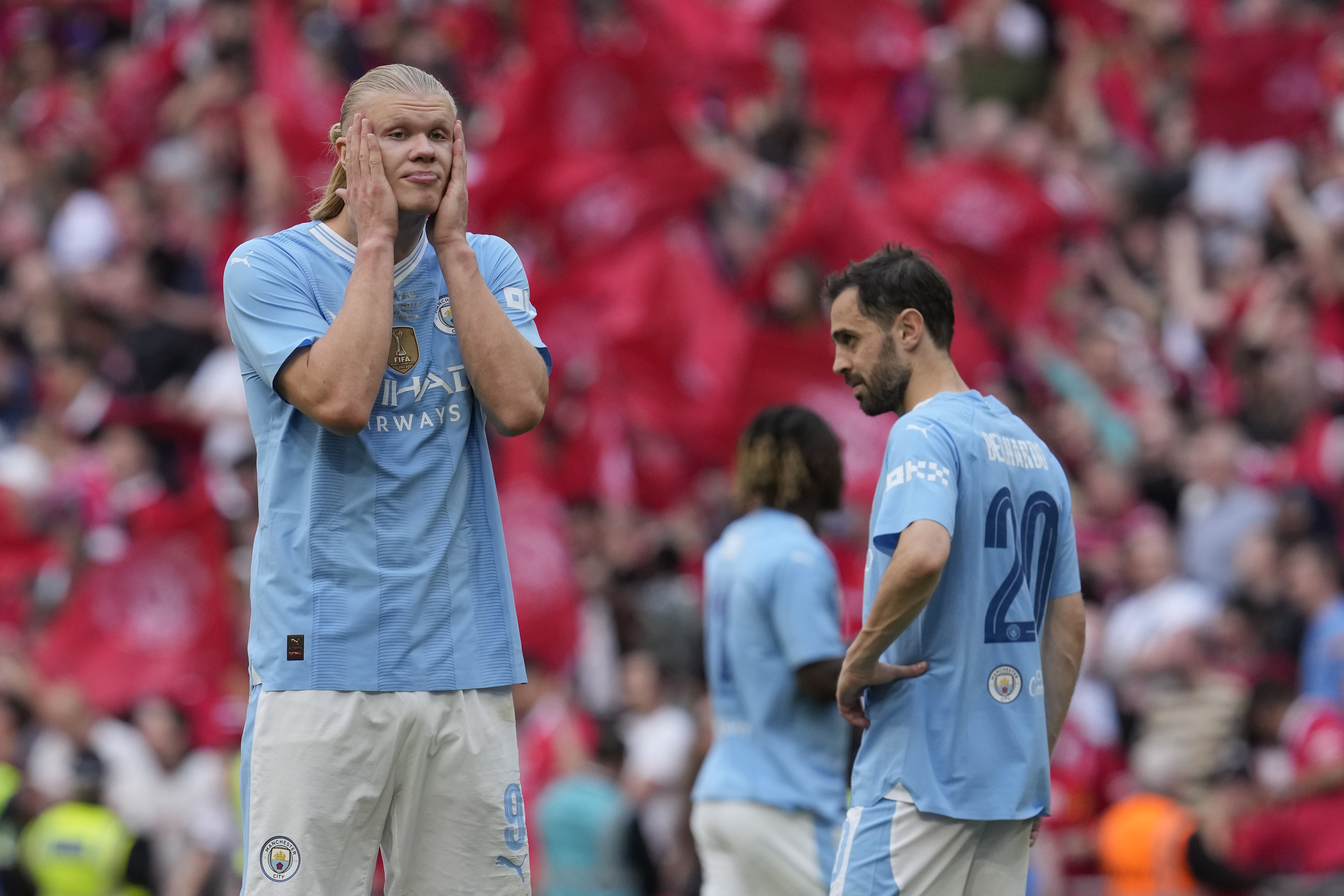 Manchester City's Erling Haaland, left, and Manchester City's Bernardo Silva react at the end of the English FA Cup final soccer match between Manchester City and Manchester United at Wembley Stadium in London, Saturday, May 25, 2024. Manchester United won 2-1. (AP Photo/Kin Cheung)