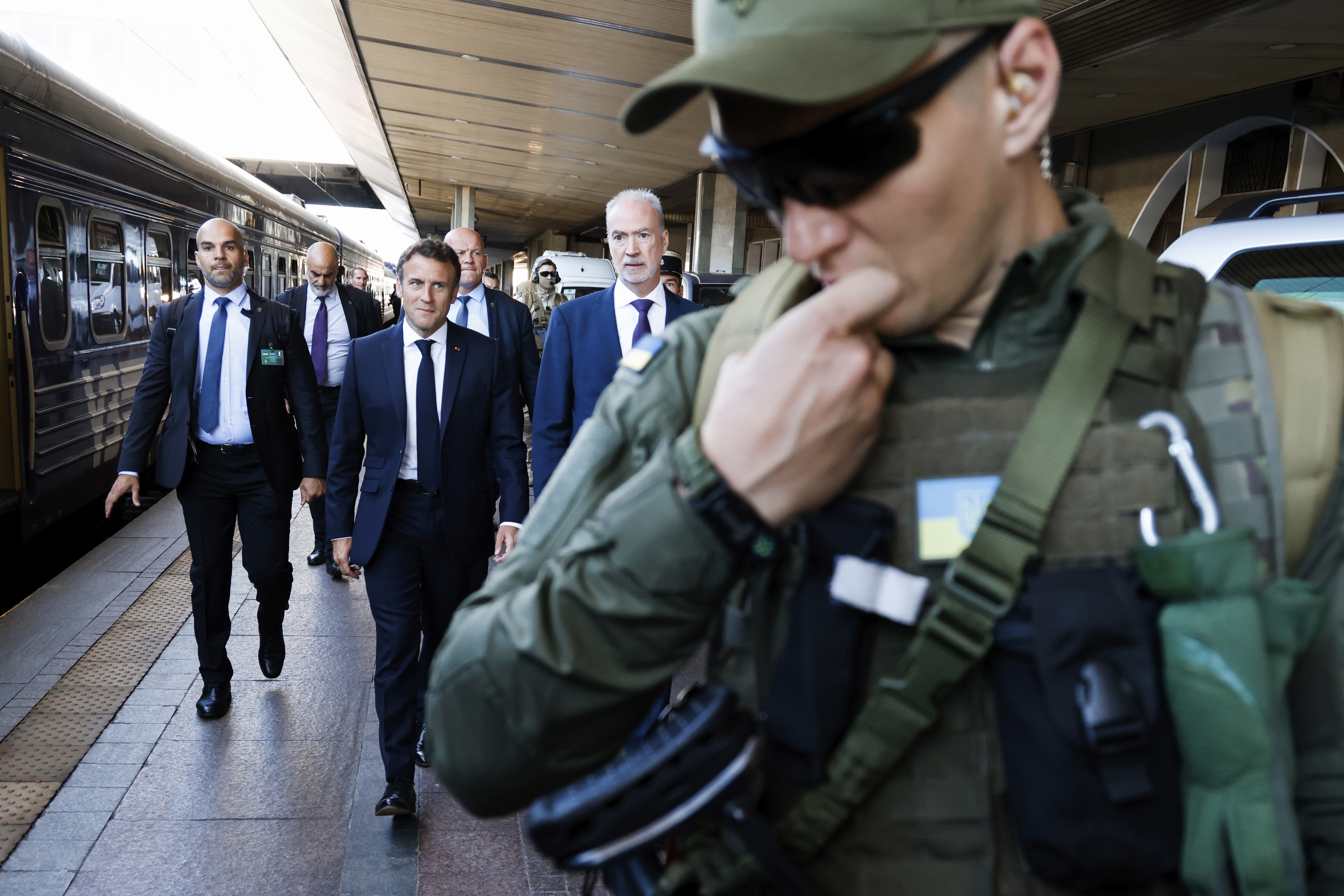 French President Emmanuel Macron, centre, is escorted as he arrives at the Kyiv train station, Thursday, June 16, 2022. French President Emmanuel Macron Prime Minister Mario Draghi and German Chancellor Olaf Scholz are expected to meet with Ukraine's President Volodymyr Zelenskyy as they prepare for a key European Union leaders' summit in Brussels next week and a June 29-30 NATO summit in Madrid.(Ludovic Marin, Pool via AP)