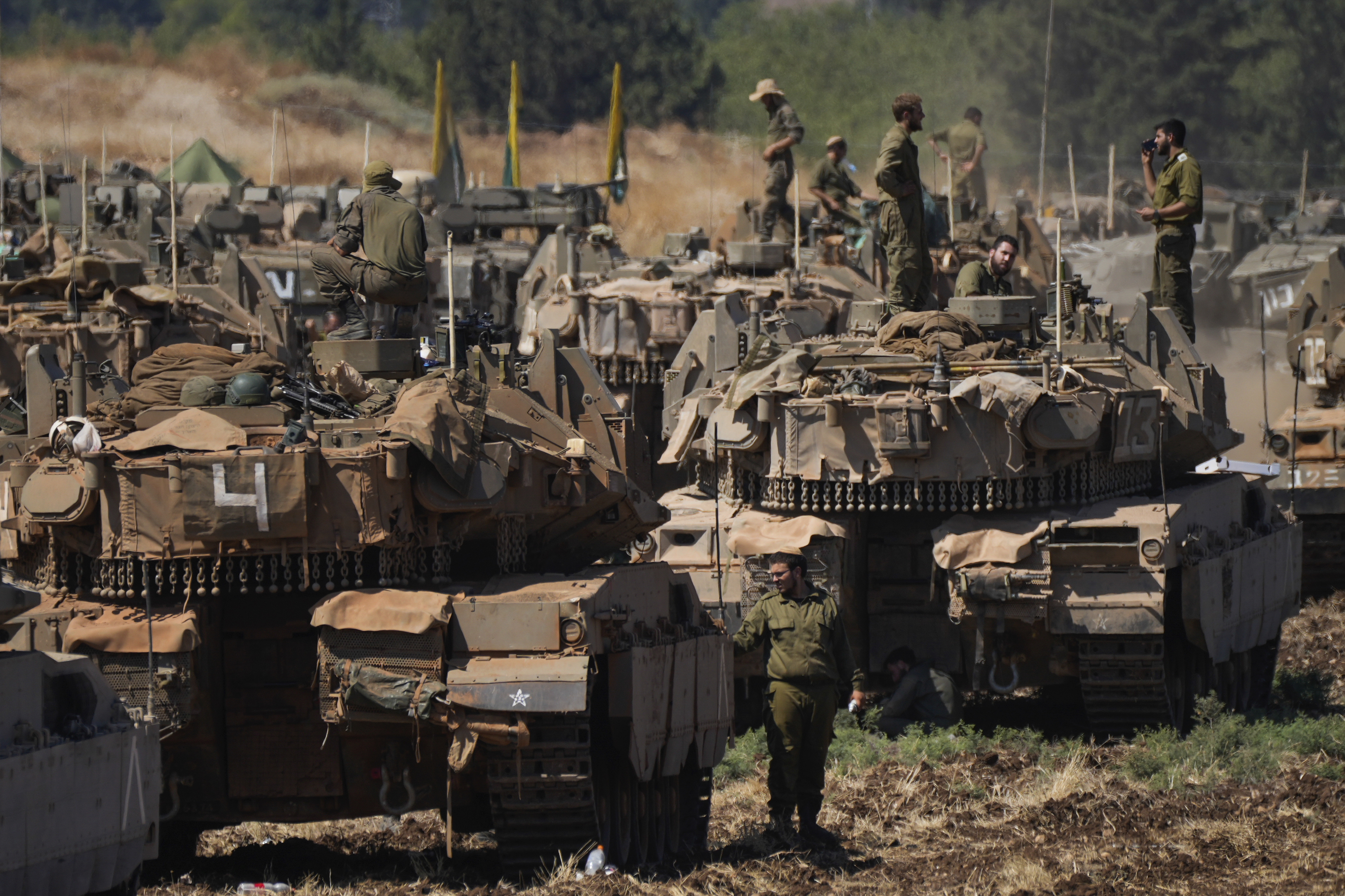 Israeli soldiers work on on an armoured personnel carrier (APC) in northern Israel.