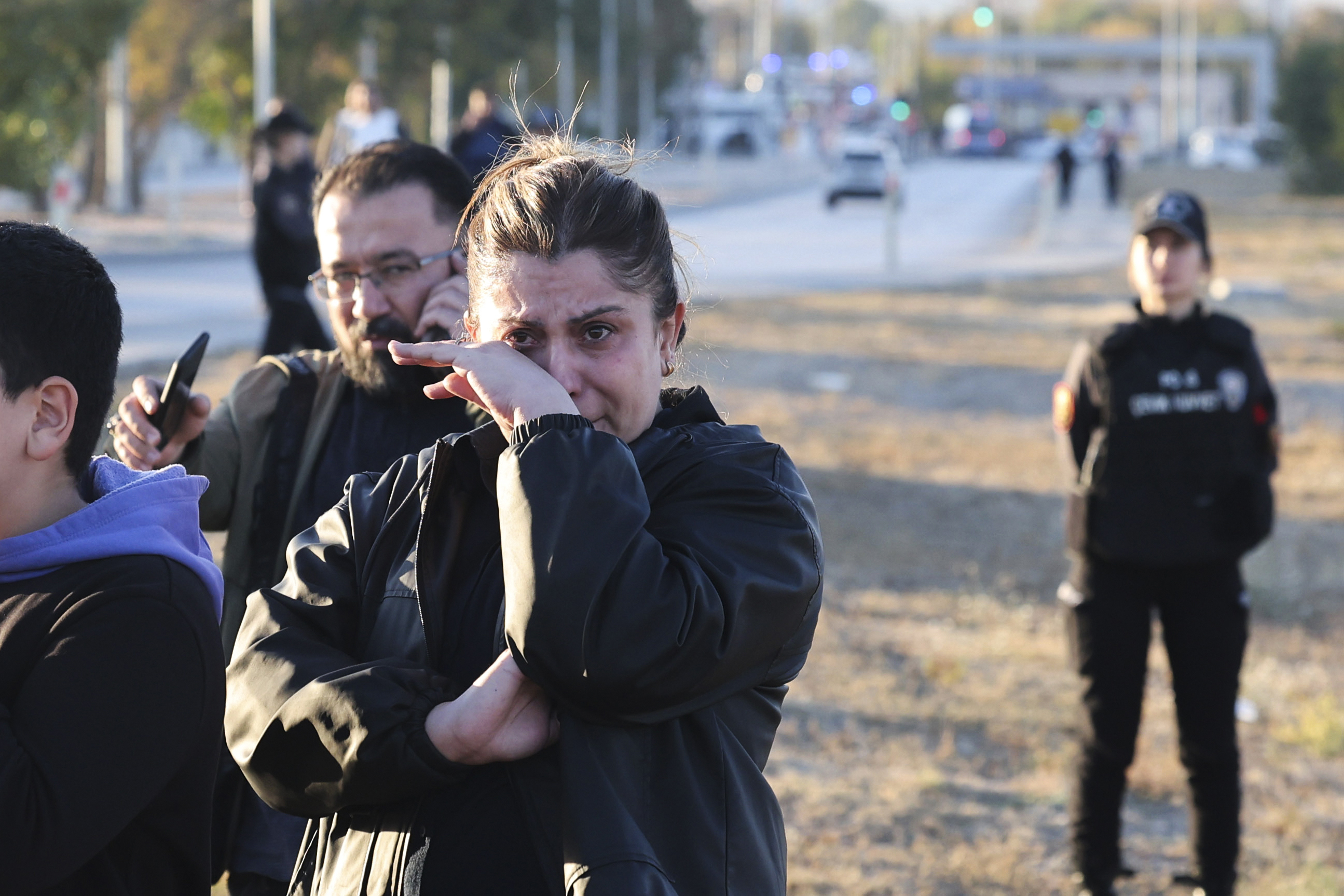 People gather outside of the Turkish Aerospace Industries Inc. on the outskirts of Ankara, Turkey, Wednesday, Oct. 23, 2024 