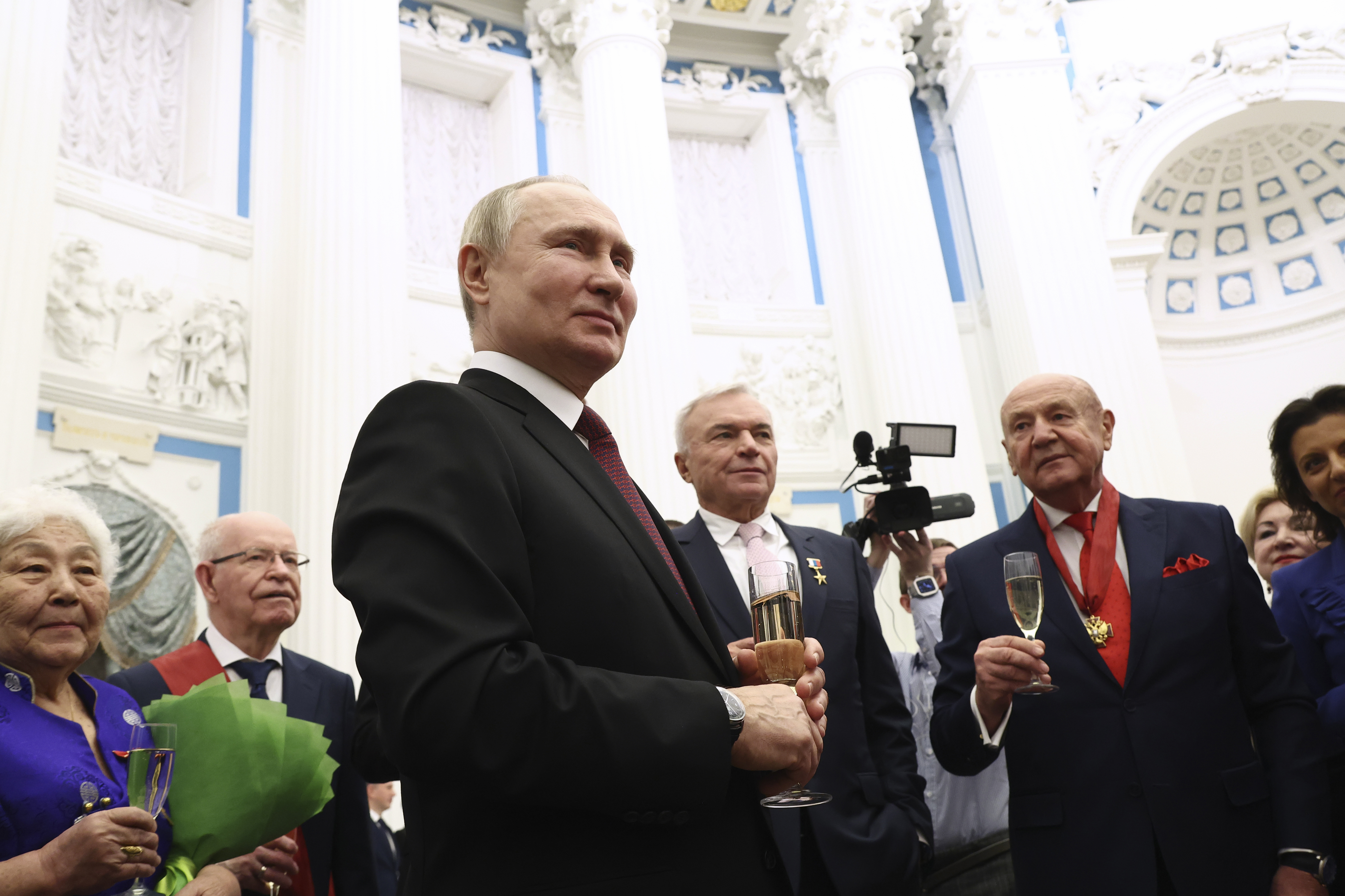 Russian President Vladimir Putin toasts with laureates of state awards during an awarding ceremony at the Kremlin's St. Catherine Hall in Moscow, Russia, Tuesday, Dec. 20, 2022 