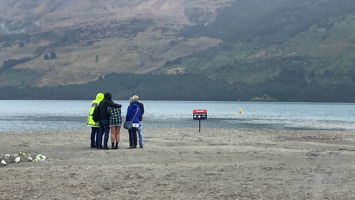 Jonathan Jordan Young's parents, brother and fiance watch on as police divers look for his body in Lake Wakatipu.