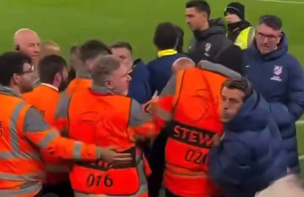 A member of Atletico Madrid's staff appears to spit at a Liverpool fan.