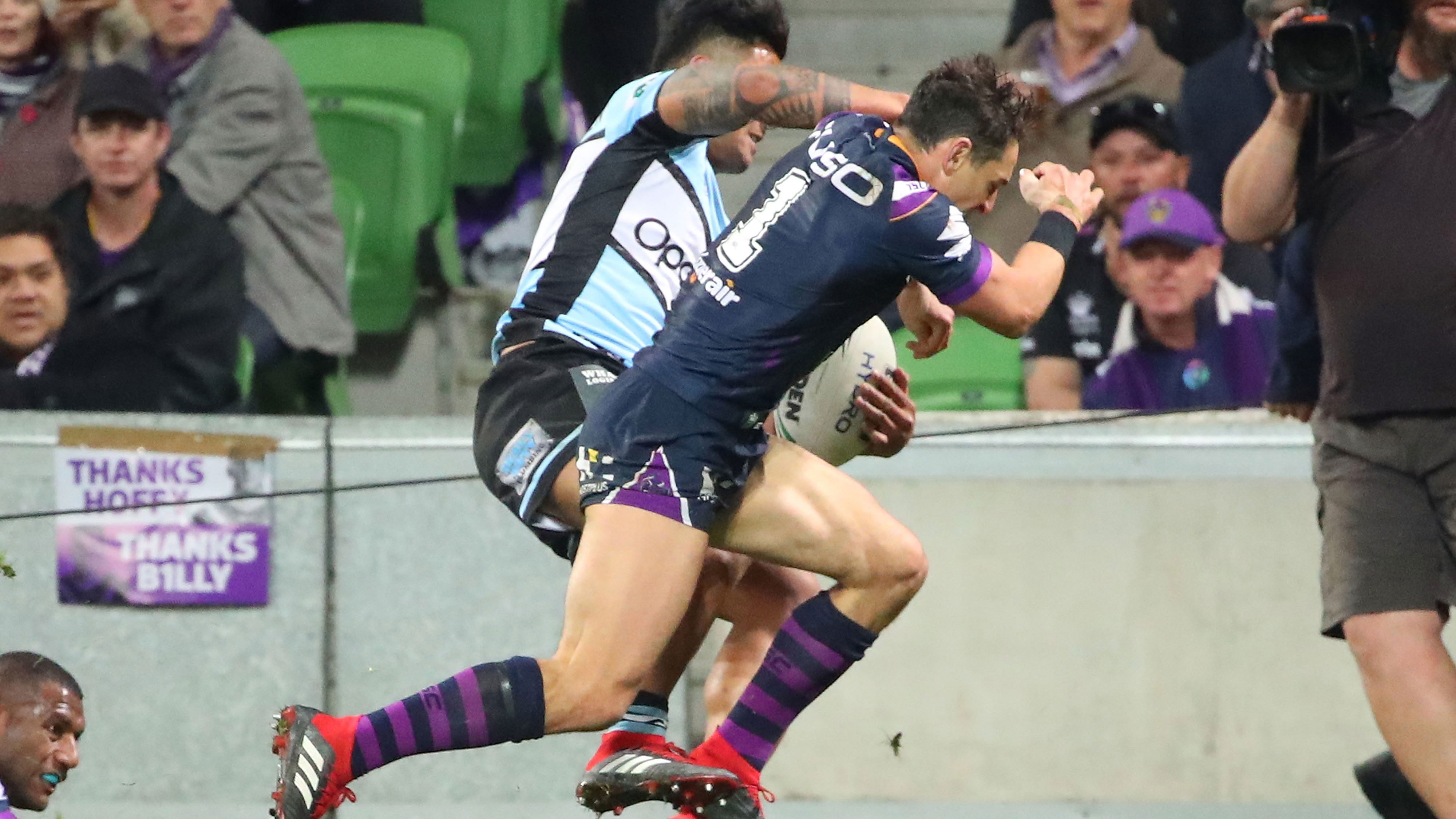 Billy Slater puts a shoulder charge on Sosaia Feki.