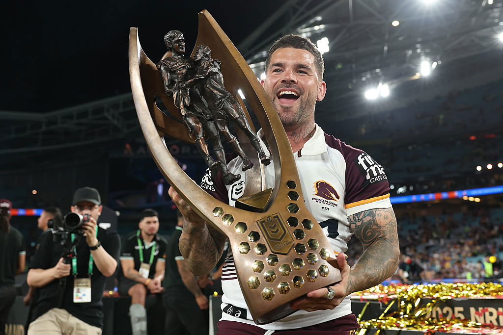Adam Reynolds of the Broncos poses with the premiership trophy.