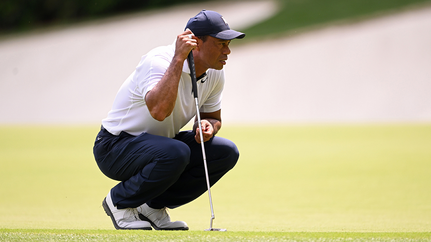 Tiger Woods studies a putt on the 13th green during the opening round at the Masters.