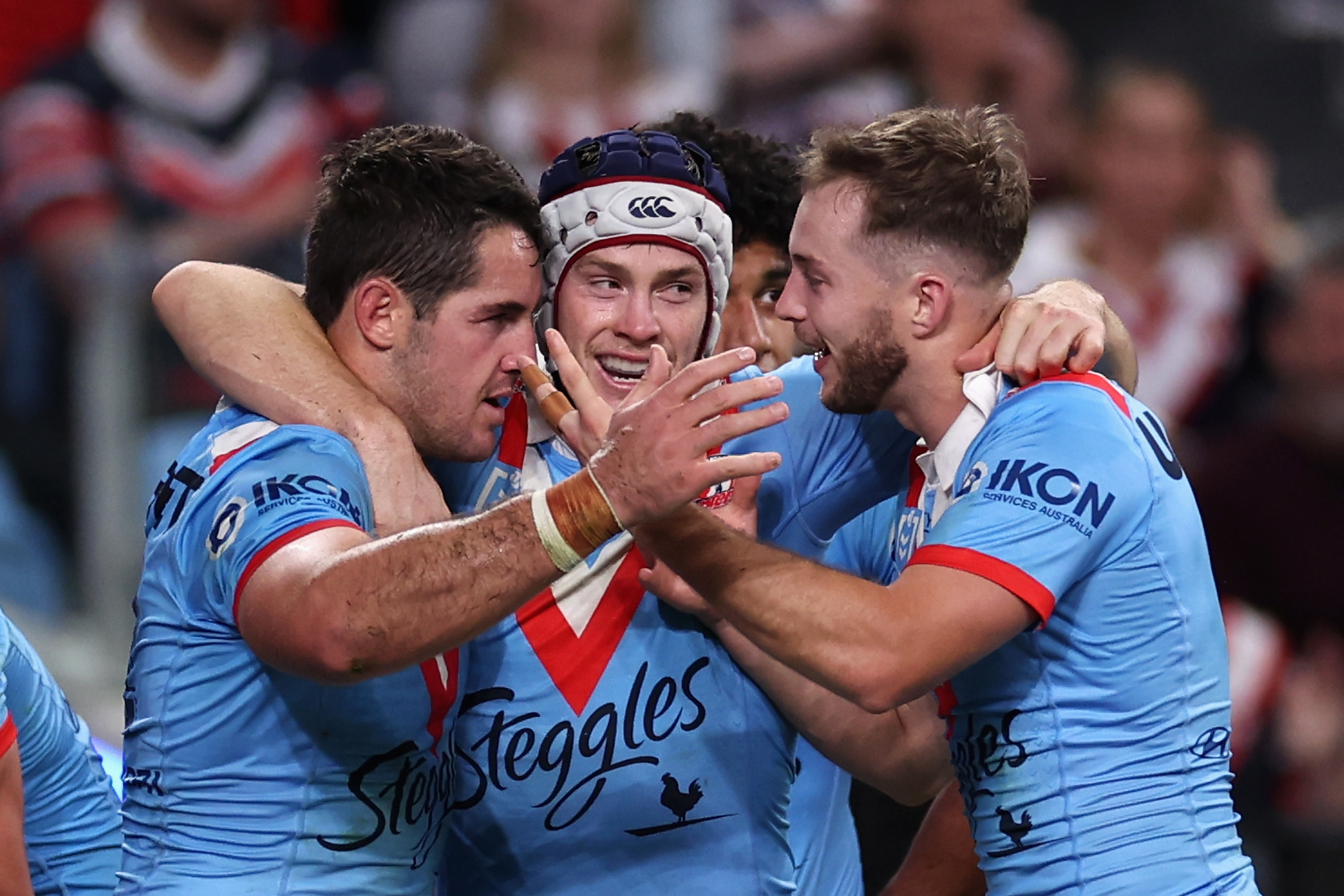 Nat Butcher of the Roosters celebrates scoring a try with teammates Luke Keary and Sam Walker.