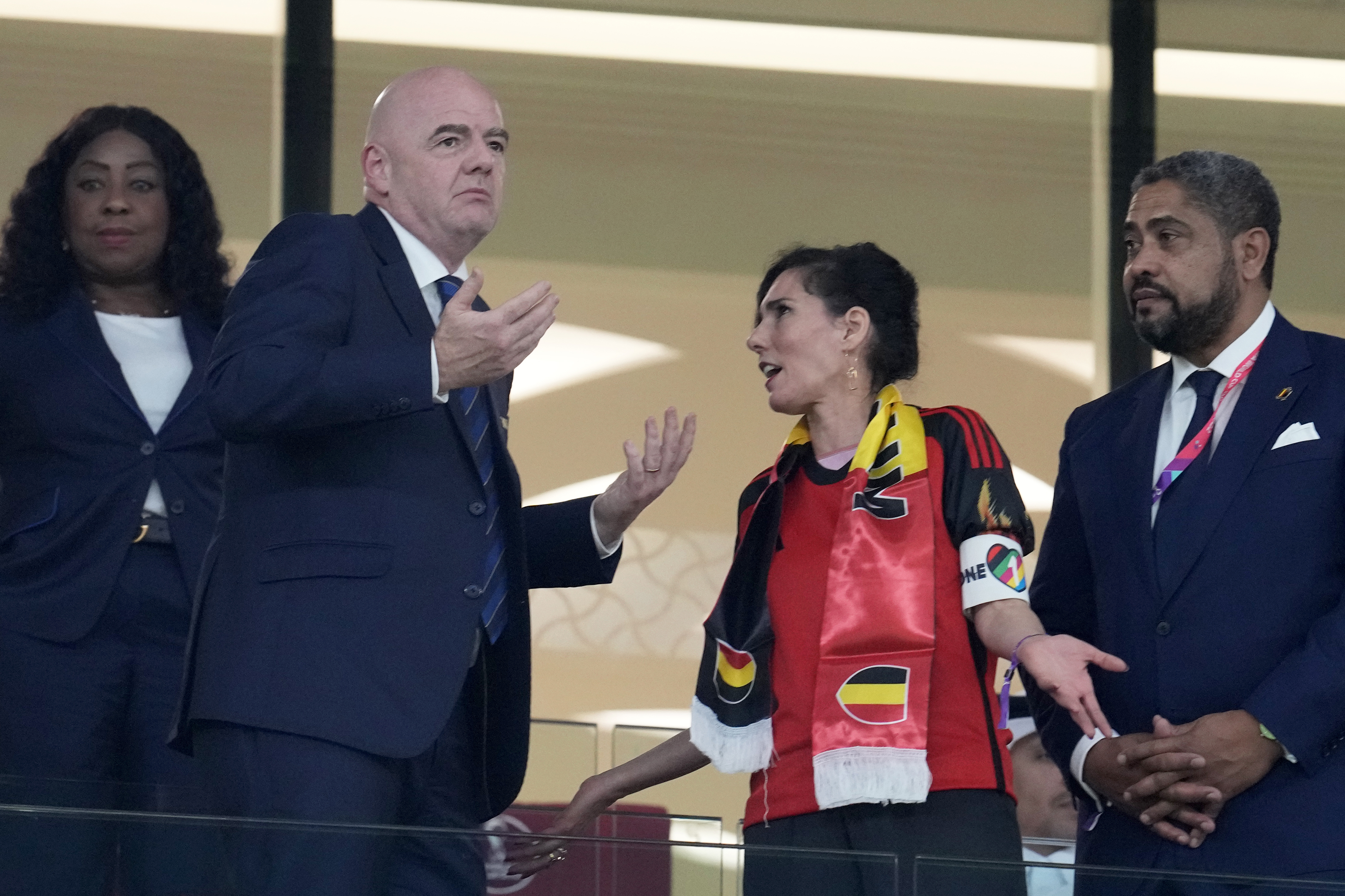 Belgium Foreign Minister Hadja Lahbib, wearing a "One Love" armband, talks with FIFA President Gianni Infantino, left, on the tribune during the World Cup group F soccer match between Belgium and Canada, at the Ahmad Bin Ali Stadium in Doha, Qatar, Wednesday, Nov. 23, 2022. (AP Photo/Natacha Pisarenko)
