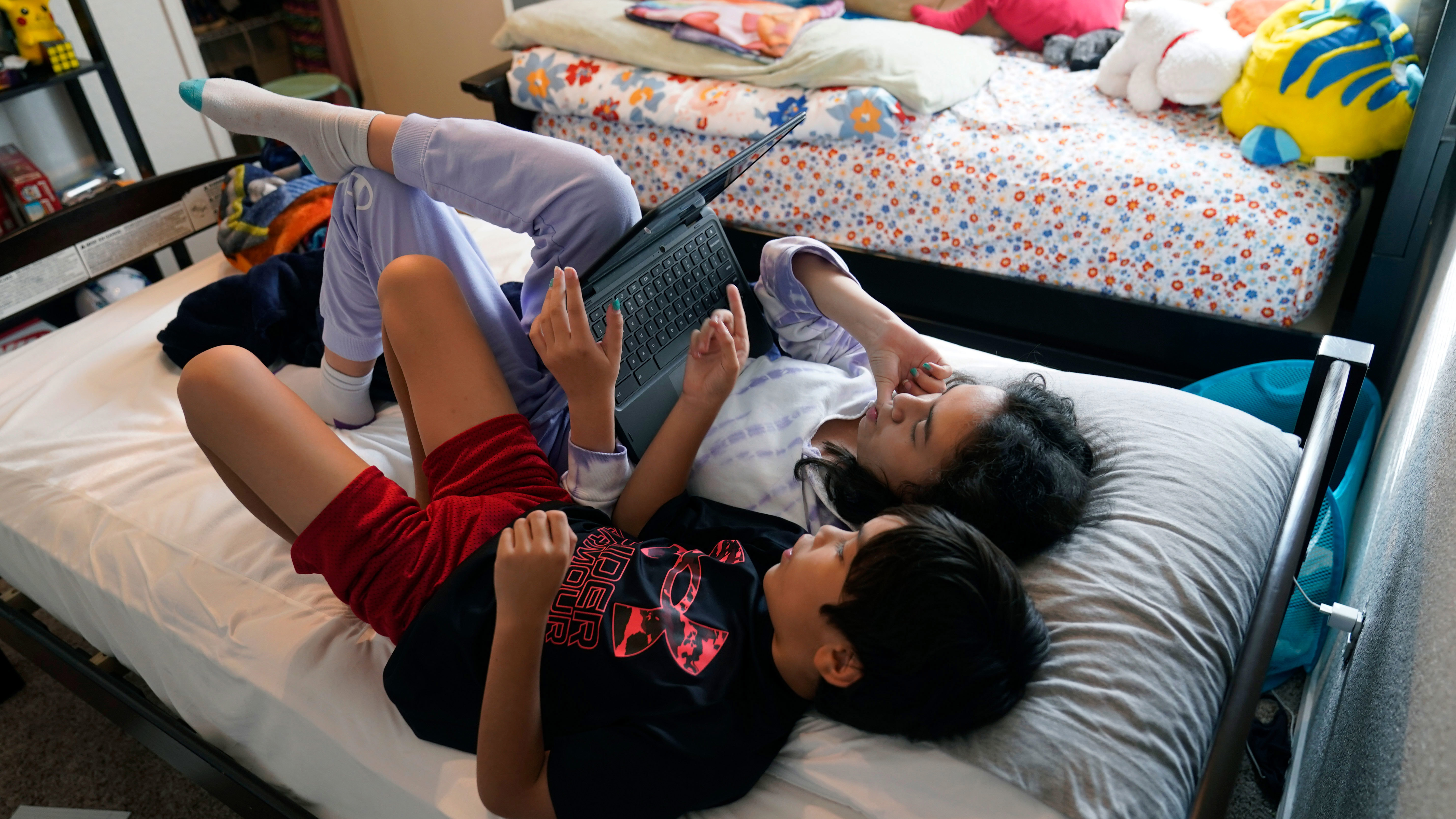 Cody and his sister Bayle look at a laptop instead of doing homework.