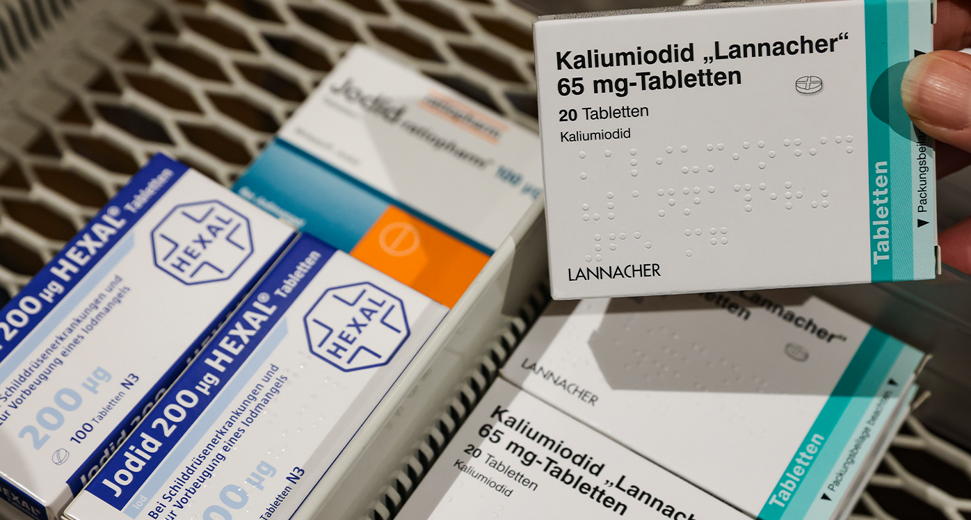 A pharmacist takes a pack of high-dose iodine tablets from a supply cabinet, next to which are weaker doses for thyroid disorders. The increased demand for iodine tablets due to the war in Ukraine could lead to problems for patients with thyroid diseases. 
