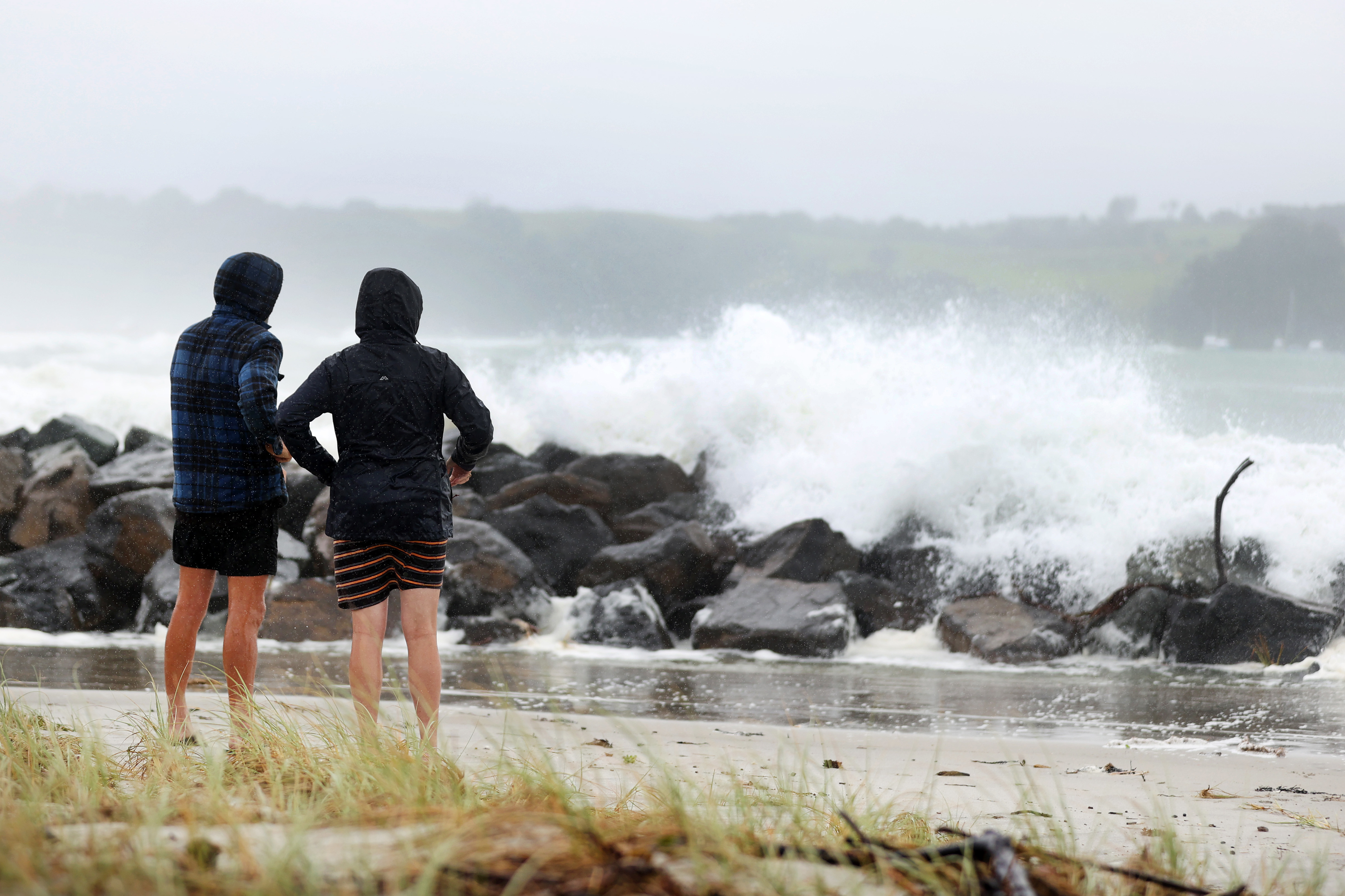 People out looking at the effects of Cyclone Gabrielle at Omaha Beach on February 13 in Auckland, New Zealand. 