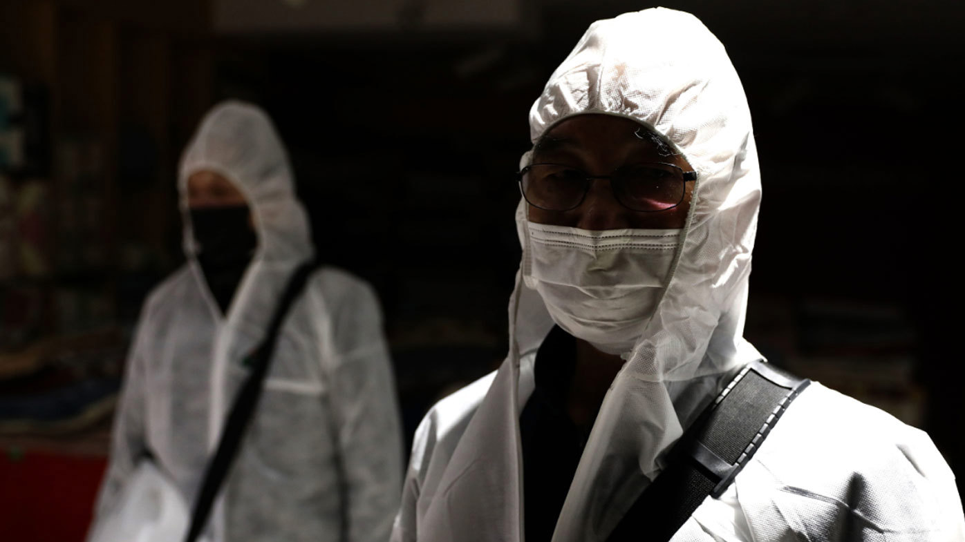 Disinfection professionals, wearing protective gear, spray antiseptic solution to guard against the coronavirus (COVID-19) at a department store on March 02, 2020 in Seoul, South Korea. 