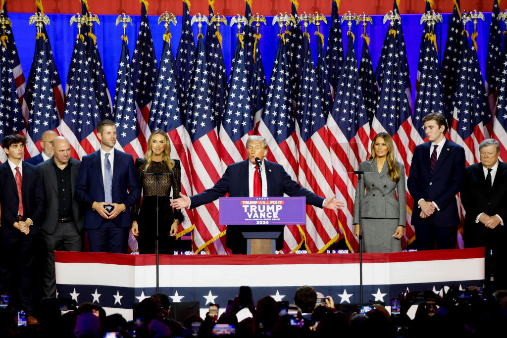 Former US President Donald Trump, center, during an election night event at the Palm Beach Convention Center in West Palm Beach, Florida, US, on Wednesday, Nov. 6, 2024. Trump is on the cusp of recapturing the White House, projected as the winner across pivotal swing states with his party set to control the Senate and markets swinging in expectation of his possible victory. Photographer: Eva Marie Uzcategui/Bloomberg