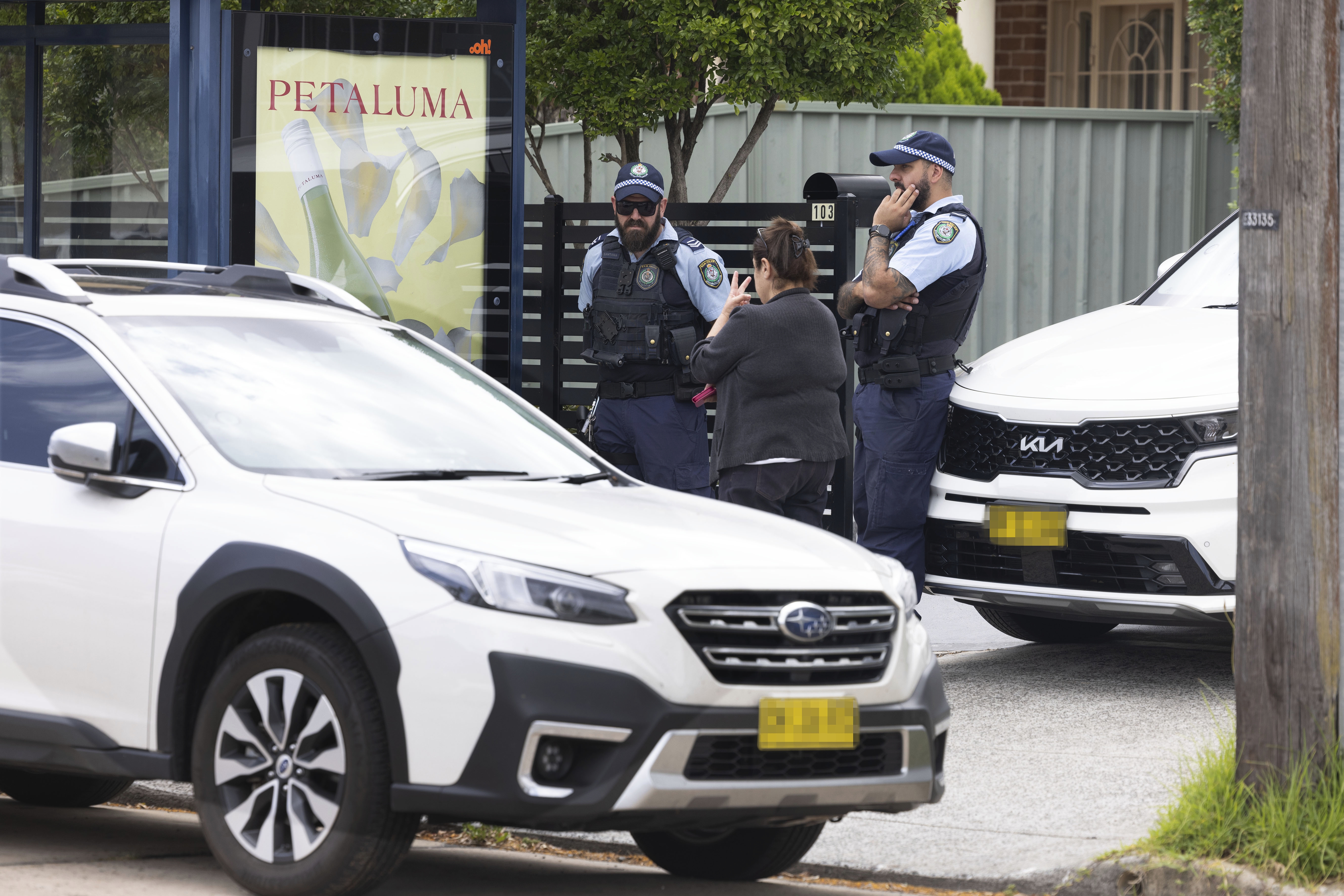 Police  talk with a local as they stand outside 103 Brighton Avenue, Campsie. The property is belived to have been rented by the gunmenyesterday who then went on tdo the  shooting rampage at Bondi Beach yesterday early evening, Sydney.