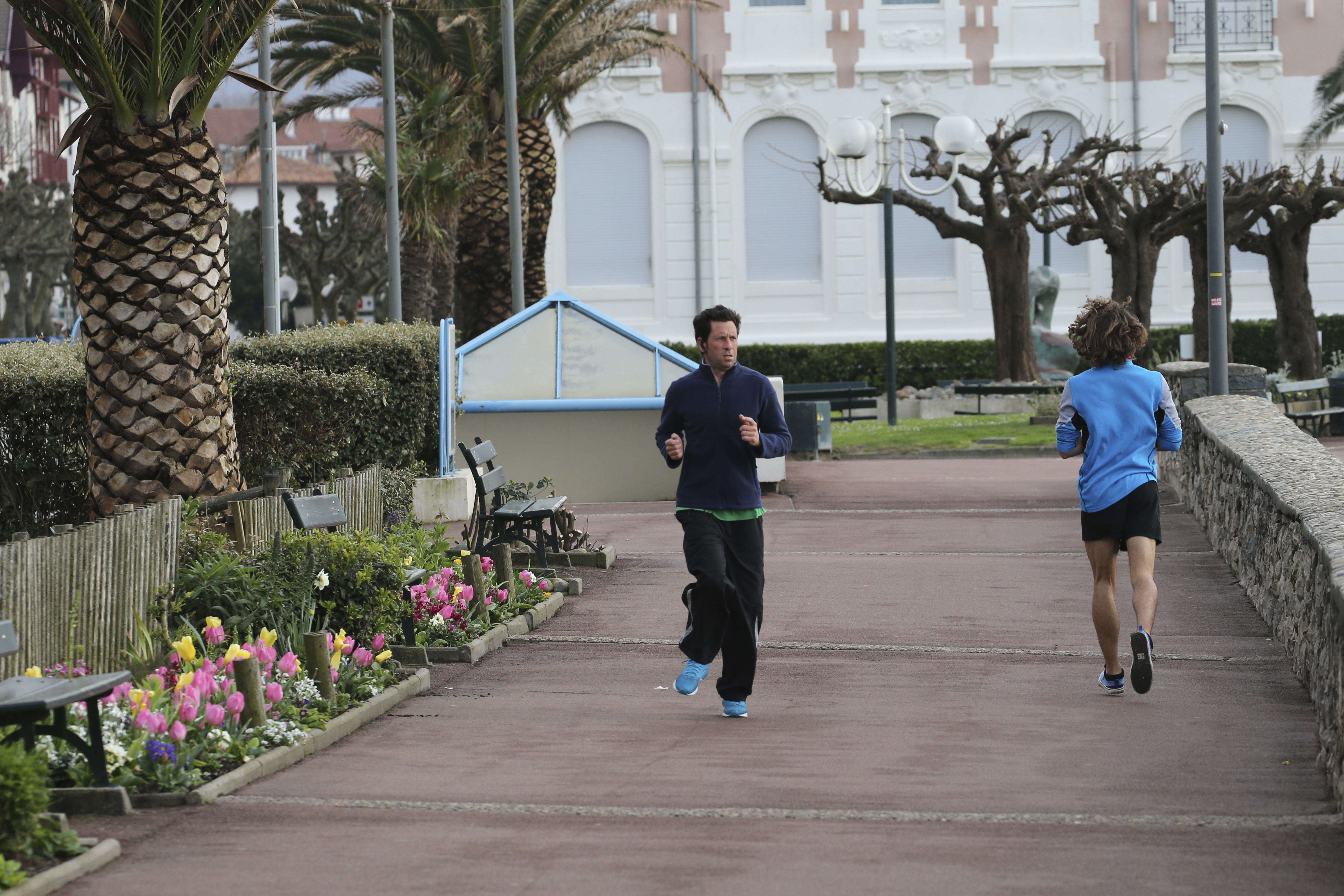 People jog along the beach promenade Tuesday, March 17, 2020 in Saint Jean de Luz, southwestern France. 
