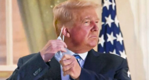 Outgoing president Donald Trump is pictured removing his mask after he left the hospital where he was being treated for the coronavirus.