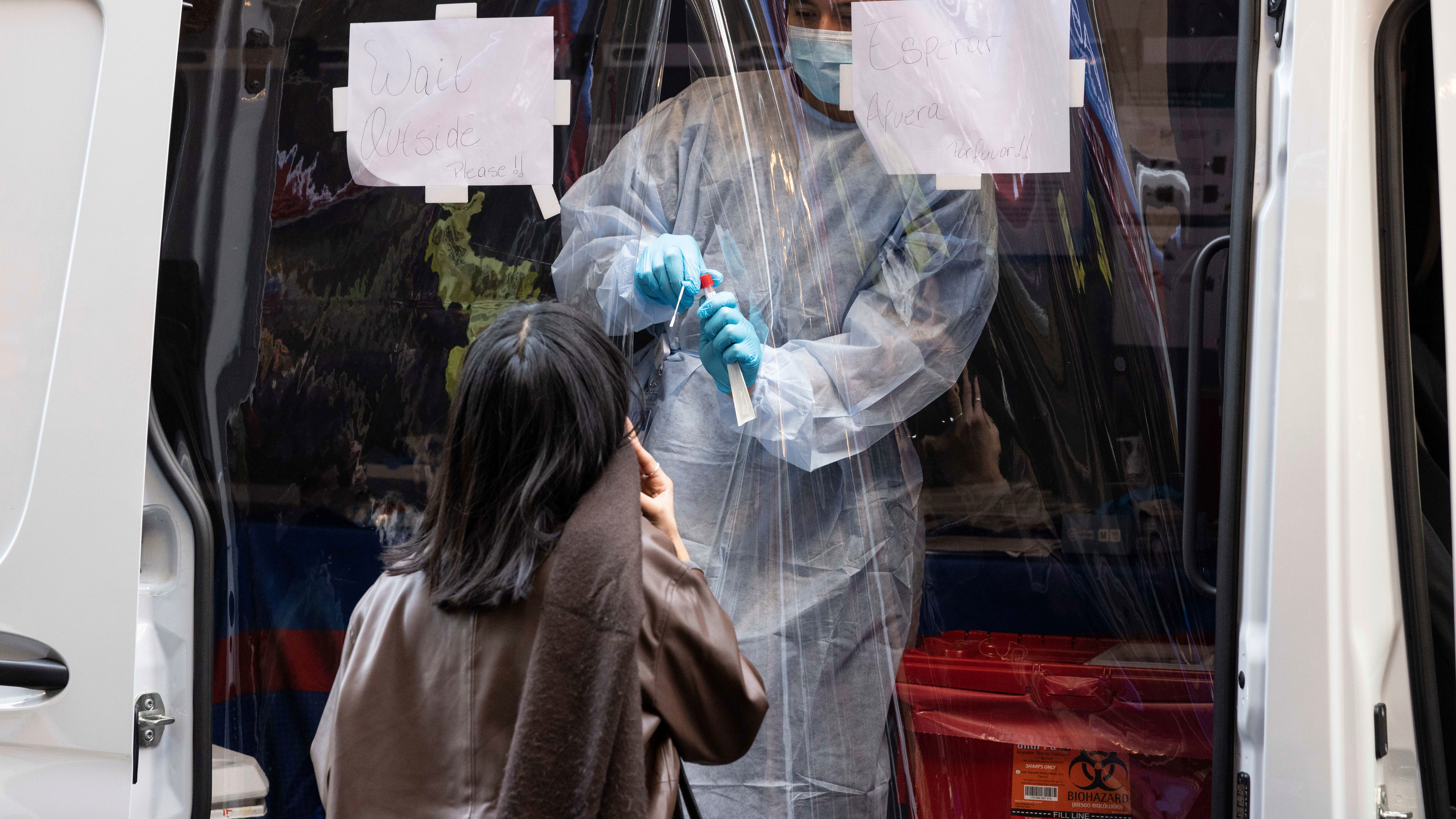 A person takes COVID-19 test at mobile testing site near Grand Central Terminal in New York.