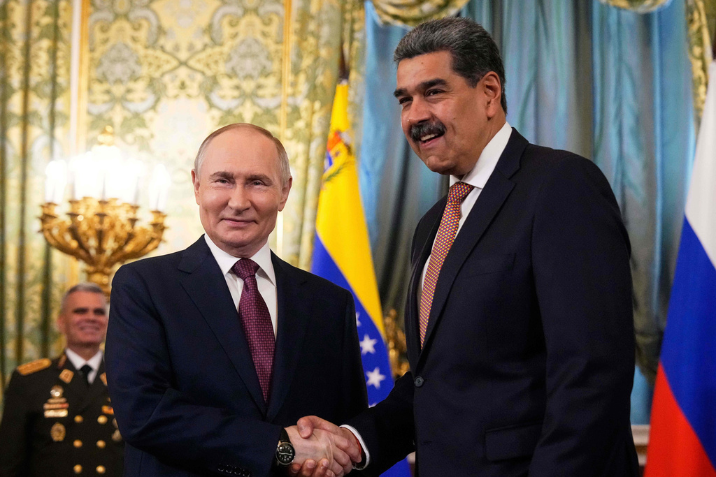 Russian President Vladimir Putin, left, shakes hands with Venezuelan President Nicolas Maduro