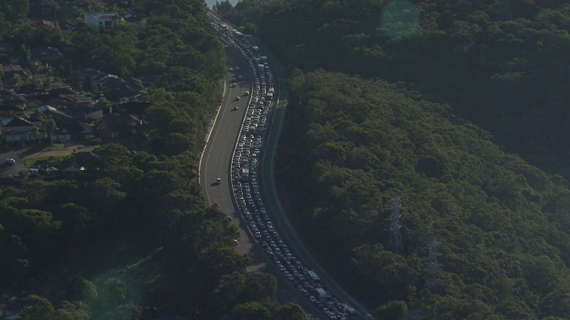 Commuters are experiencing up to an hour and 40 minutes of traffic delays after a man died by crashing his ute in a high-speed police chase in Menai.