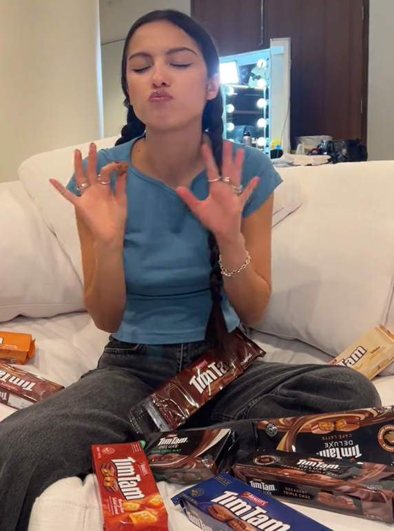 Olivia Rodrigo trying Tim Tams while in Australia for her Guts World Tour. 