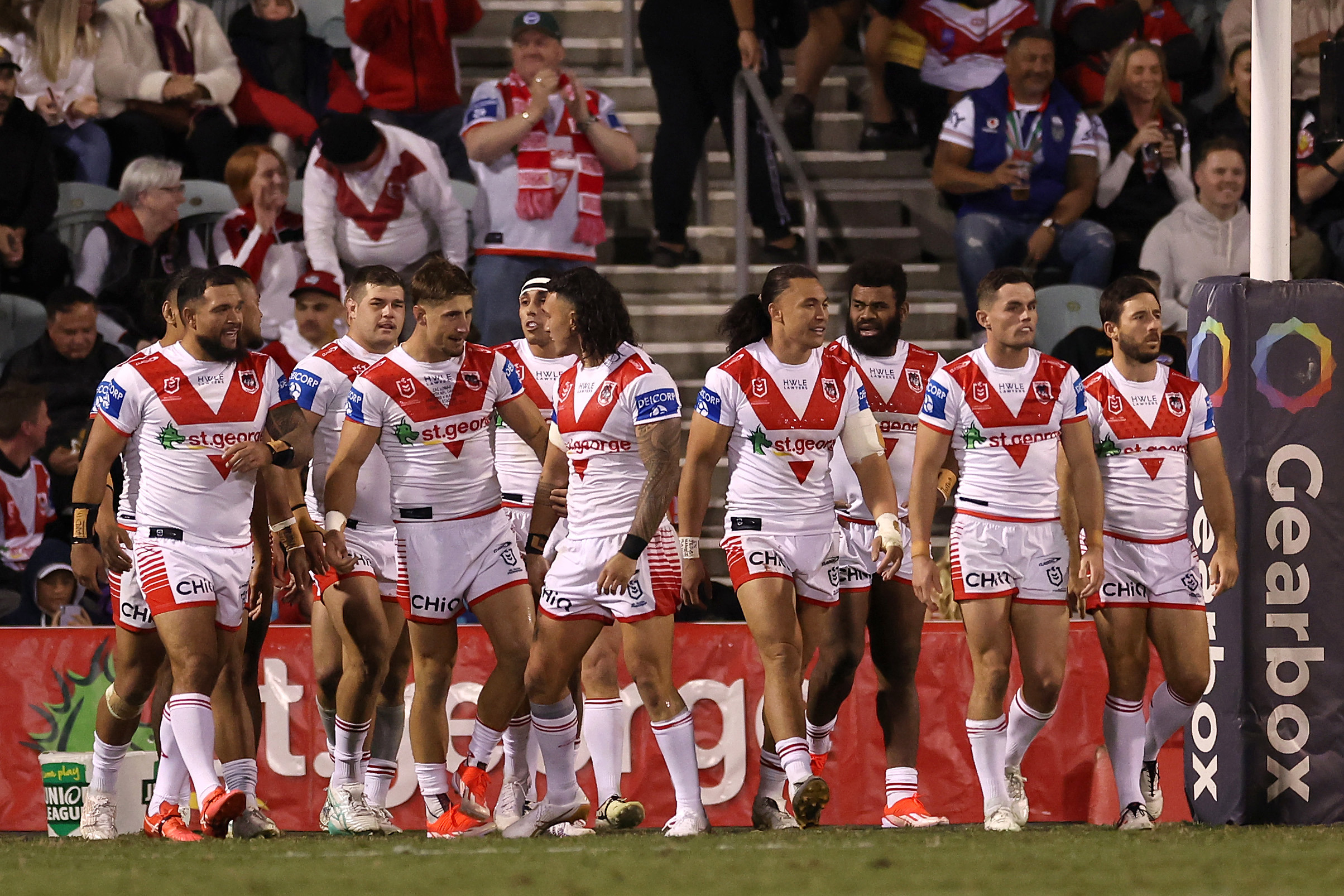 The Dragons celebrate a try against the Warriors.