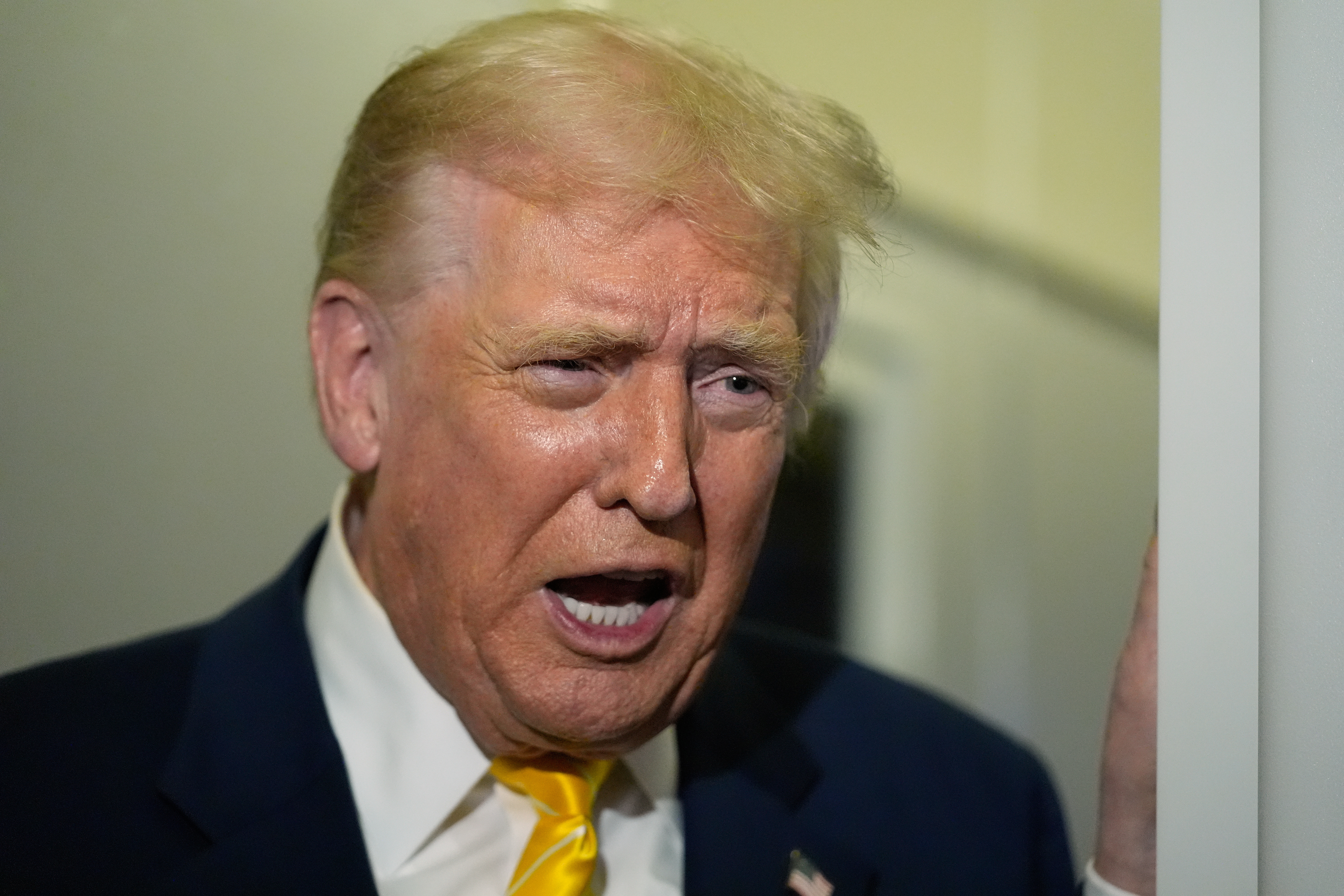 President Donald Trump speaks to reporters on Air Force One on his way to his Mar-a-Lago estate in Palm Beach, Fla., Friday, Nov. 14, 2025. (AP Photo/Manuel Balce Ceneta)