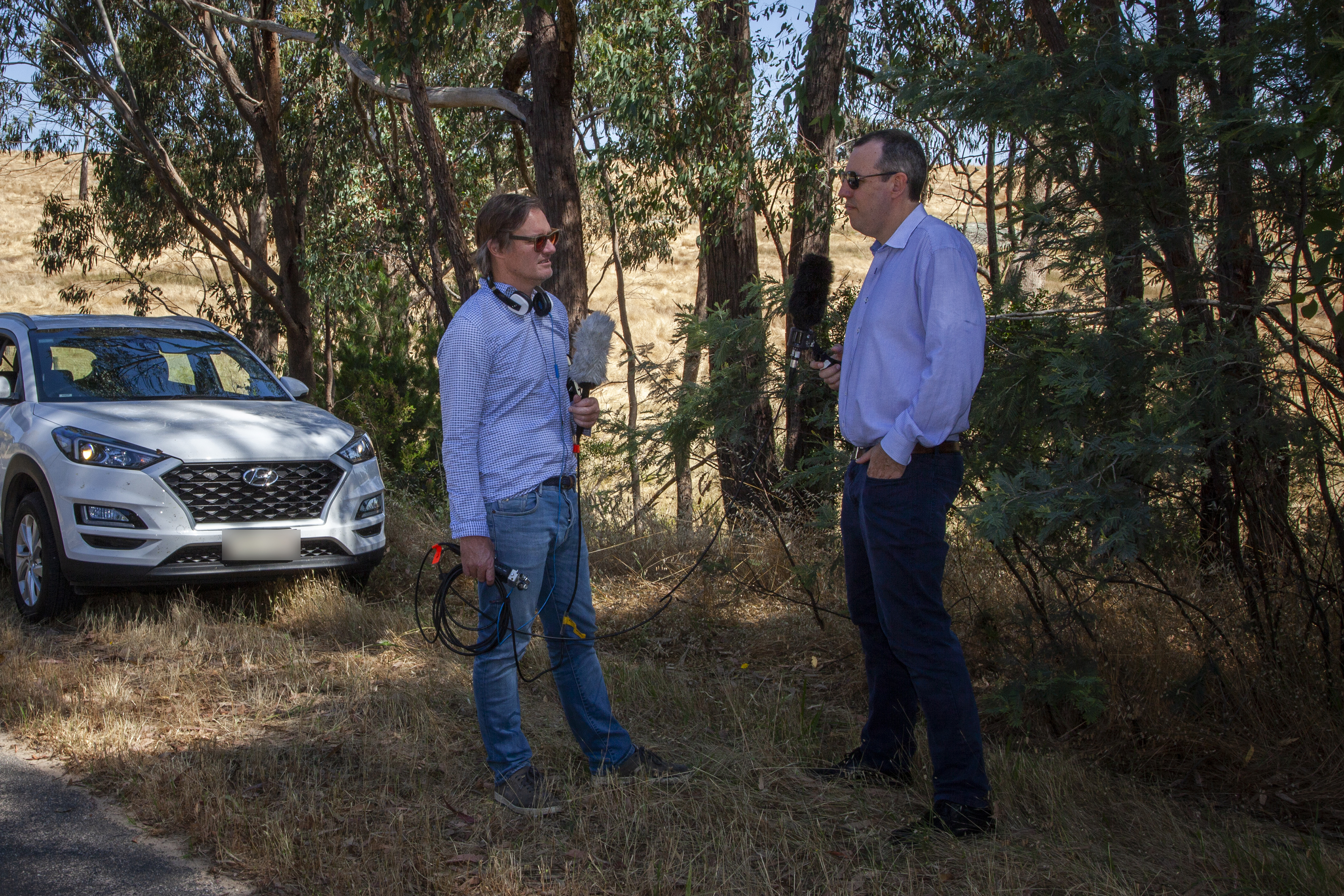 AFR journalist Angus Grigg interviews Professor Clinton Free, of the University of Sydney Business School, near the Beechworth Correctional Centre. Credit: Tim Mummery 