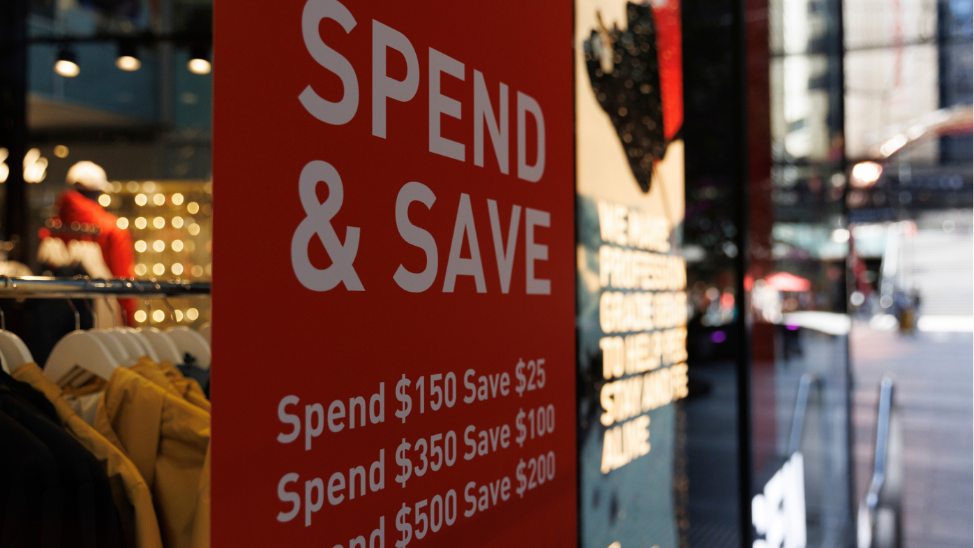 Sale sign in the window of a clothing shop. 