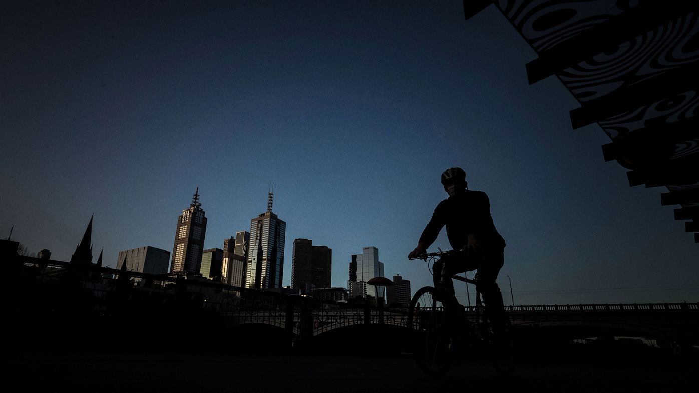 A man rides his bike along a very quiet Southbank.