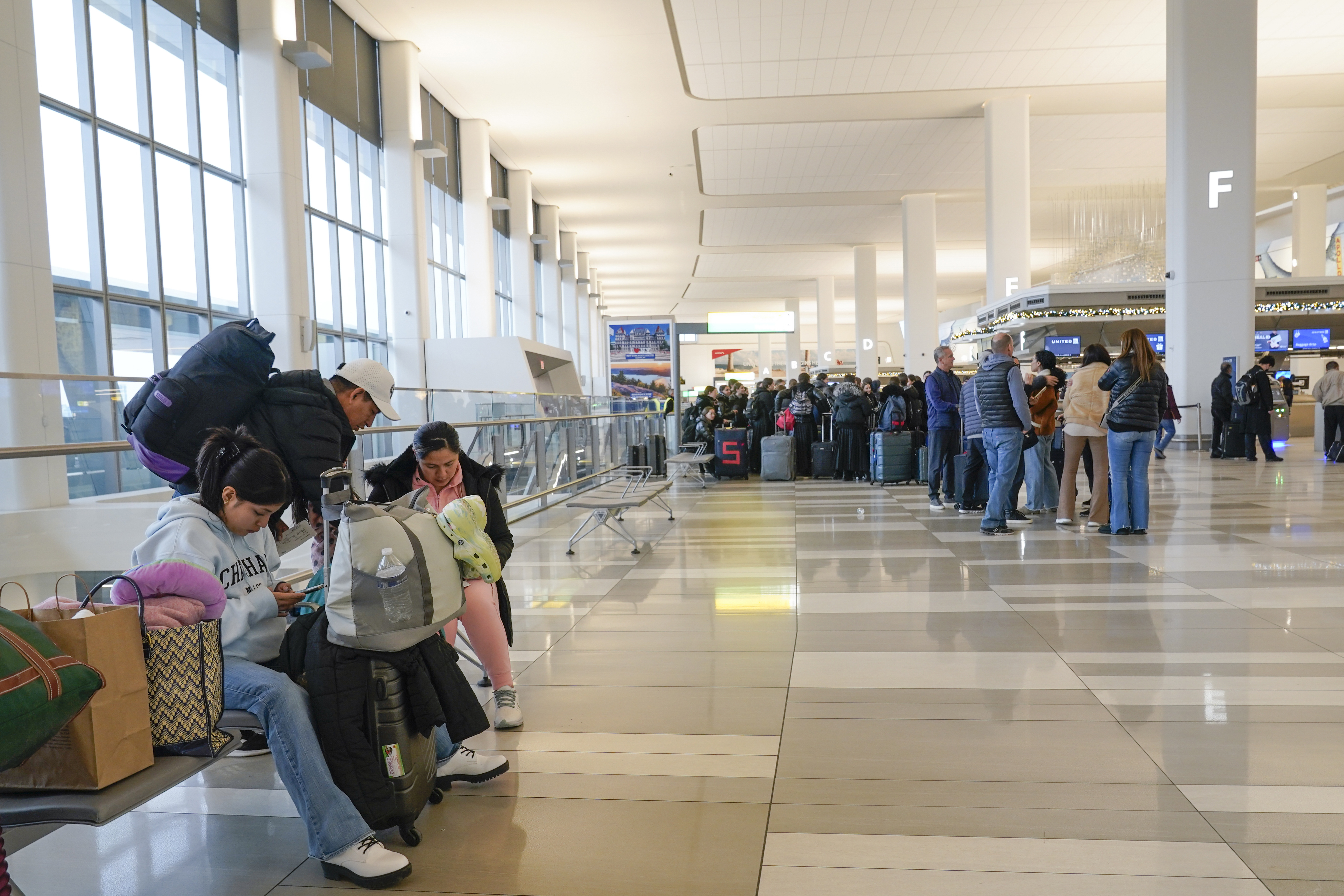 Los viajeros se paran en la sala de salidas de la Terminal B del Aeropuerto LaGuardia en Nueva York, el miércoles 11 de enero de 2023. 