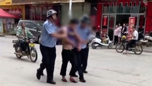 A suspect is arrested by police after a stabbing rampage at a kindergarten in Beiliu City.