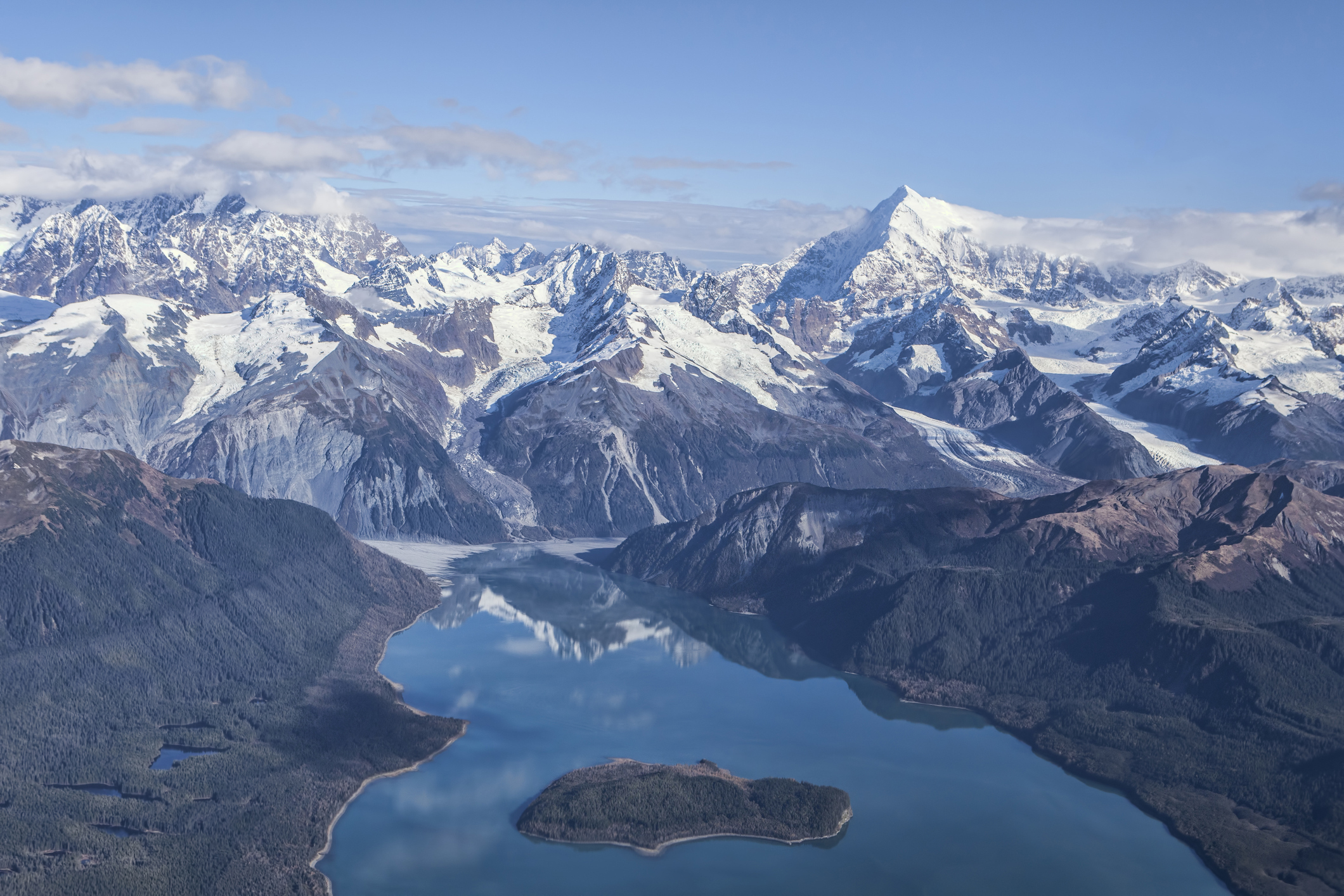 Aerial of Lituya Bay with Mt. Fairweather range in the background on a sunny day.