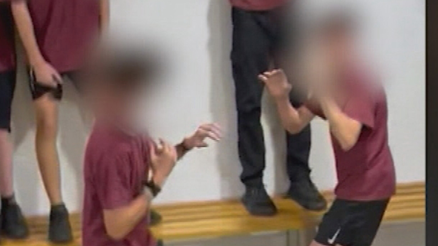 More than a dozen students at an Adelaide high school have been suspended after organising and filming a brawl at lunchtime.