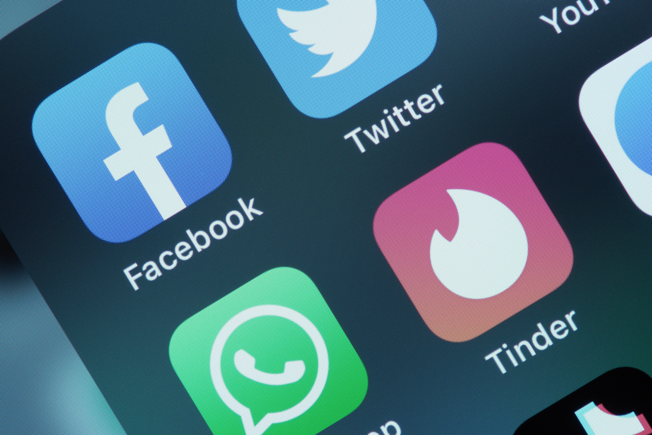  Tinder and Facebook application on screen Apple iPhone X. The composition is on a neutral background and shows the icons.
