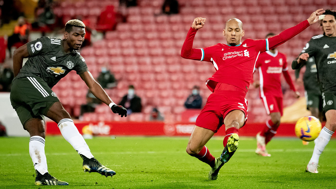 Paul Pogba of Manchester United competes with Fabinho of Liverpool 