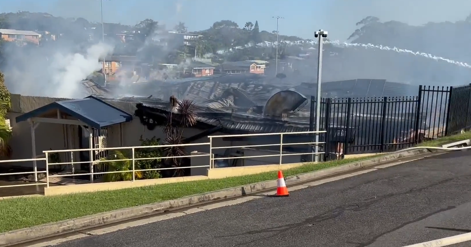 A lack of water supply and several nearby gas cylinders ﻿are threatening to worsen a destructive fire that engulfed a beloved sports club in NSW's Mid North Coast.