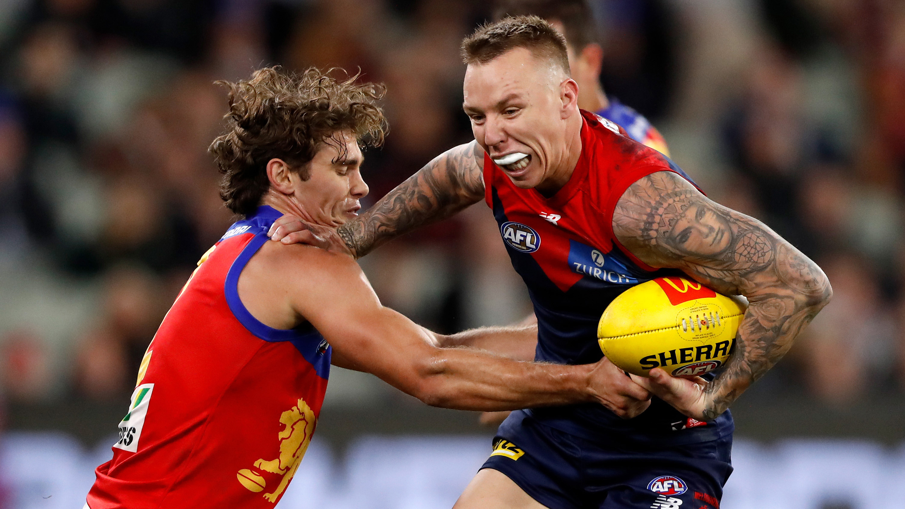 James Harmes of the Demons is tackled by Deven Robertson of the Lions during the 2022 AFL Round 15 match between the Melbourne Demons and the Brisbane Lions at the Melbourne Cricket Ground on June 23, 2022 in Melbourne, Australia. (Photo by Dylan Burns/AFL Photos via Getty Images)