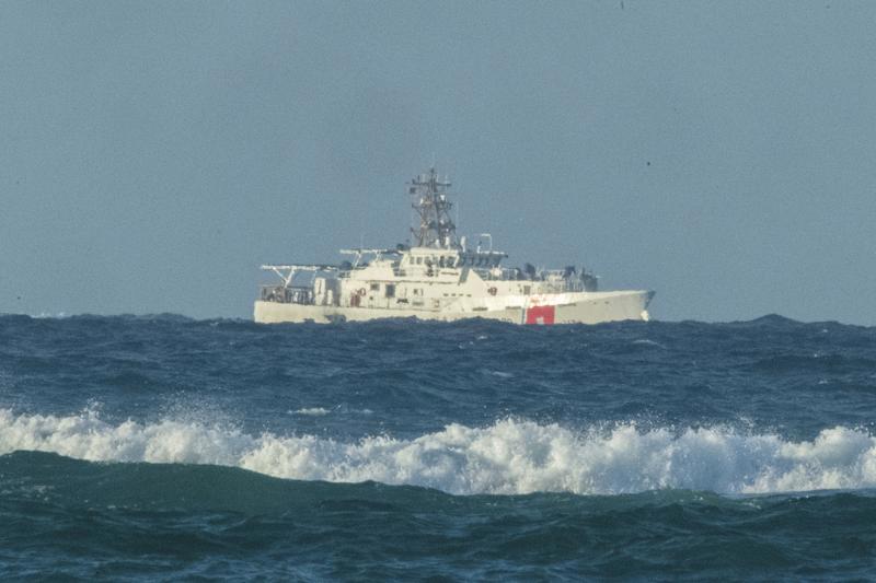 A U.S. Coast Guard cutter patrols the area of debris from a 737 cargo plane that crashed off Oahu. 