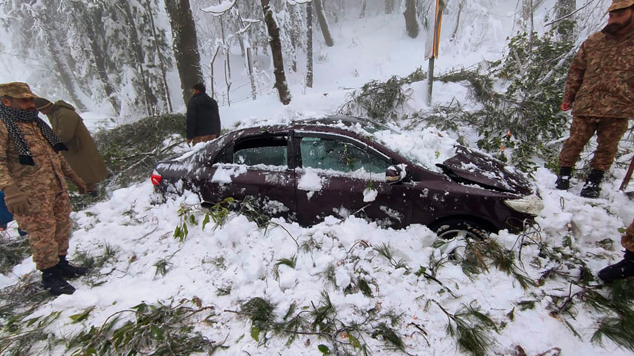 In this photo provided by the Inter Services Public Relations, army troops take part in a rescue operation in a heavy snowfall-hit area in Murree, 45 km north of the capital of Islamabad, Pakistan.