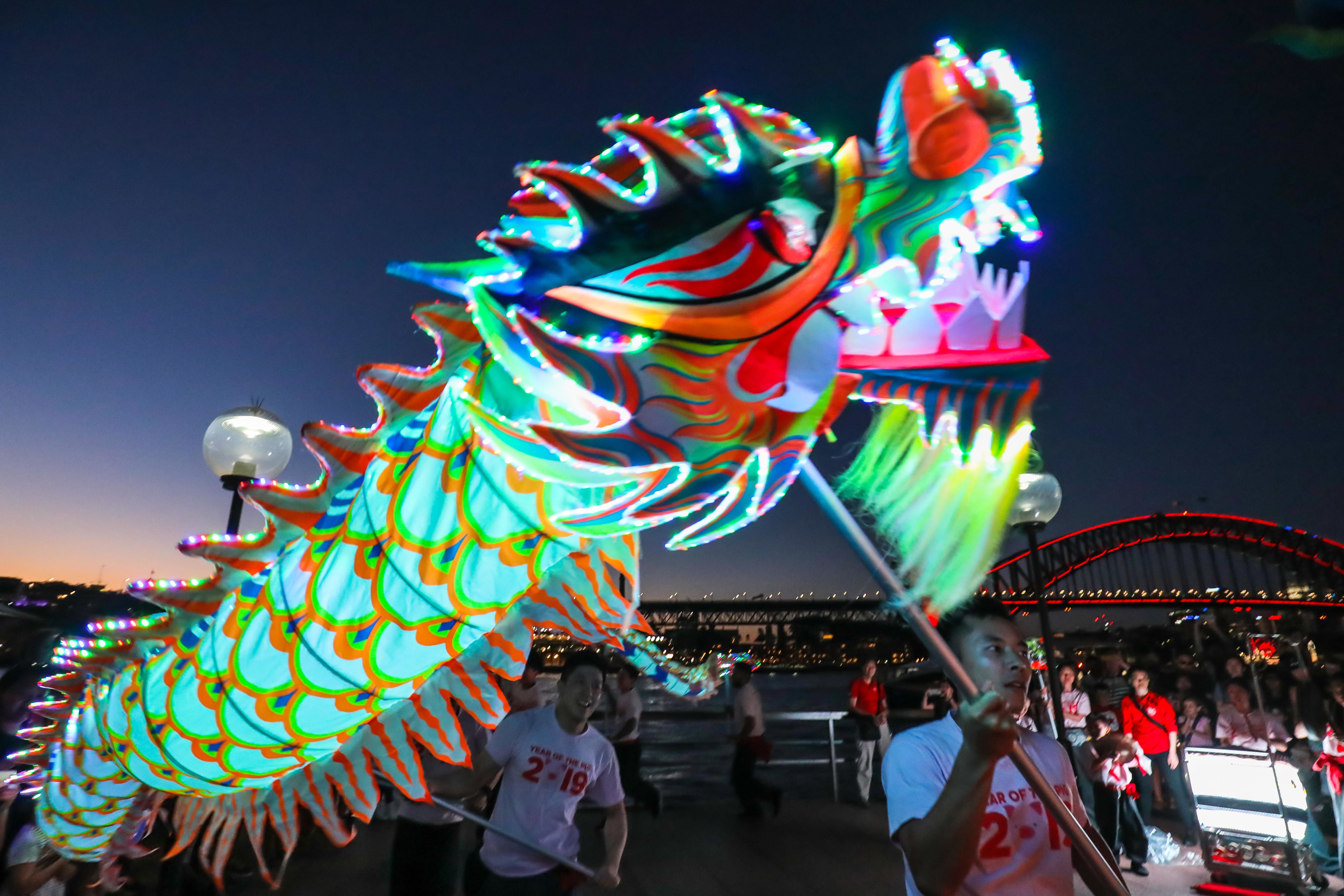 Circular Quay, Sydney - 9th February 2019. City of Sydney present Sydney Lunar Festival. People enjoy an LED lion and dragon performance in front of the monkey lantern.