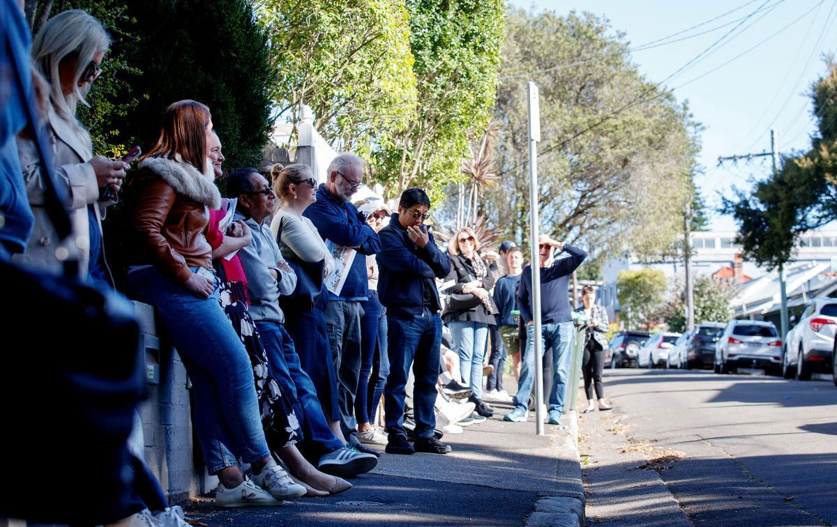 A crowd gathered to view a real estate auction.