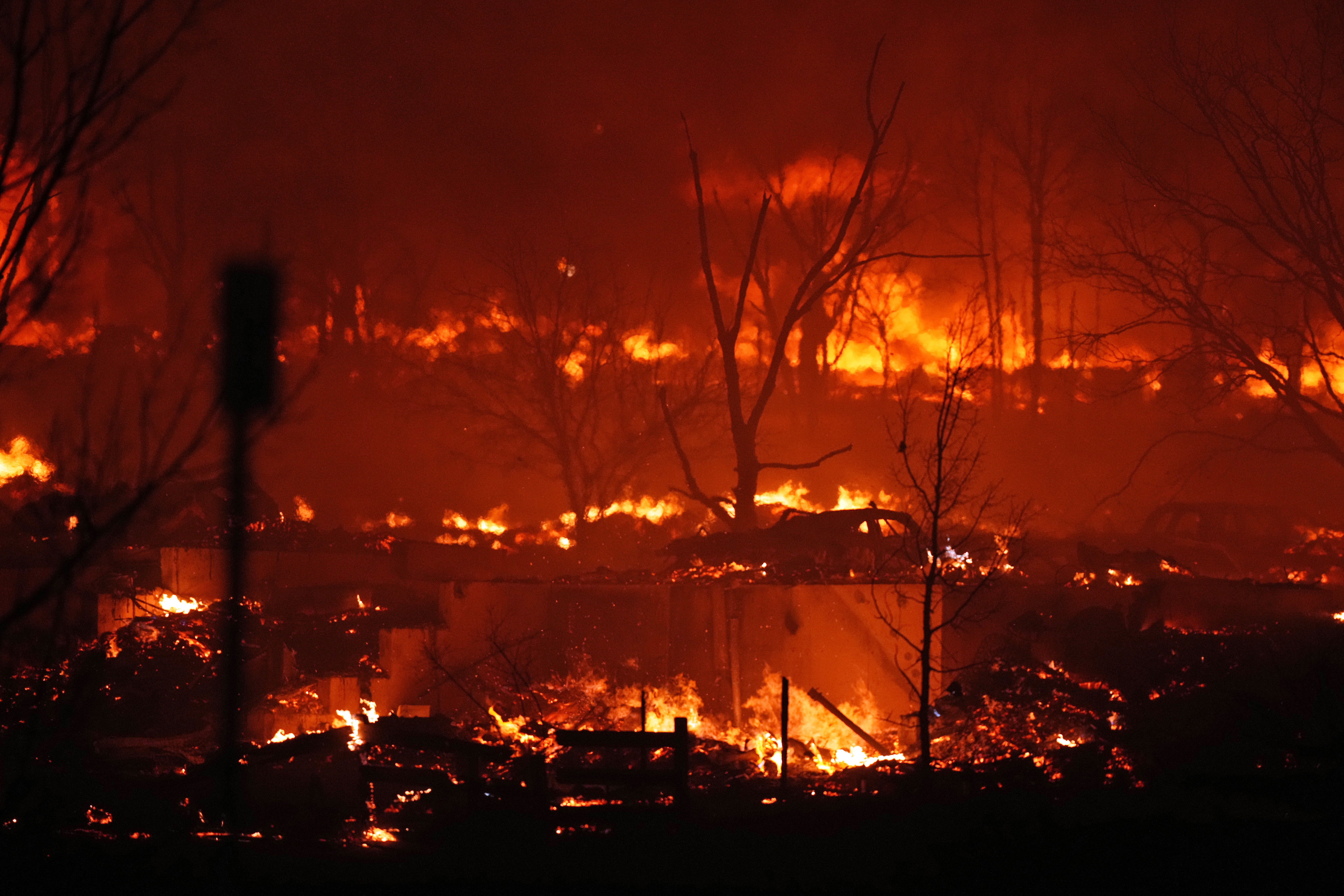 Homes burn as wildfires rip through a development near Rock Creek Village, near Broomfield, Colorado. Homes surrounding the Flatiron Crossing mall were being evacuated as wildfires raced through the grasslands as high winds raked the intermountain West. (AP Photo/David Zalubowski)