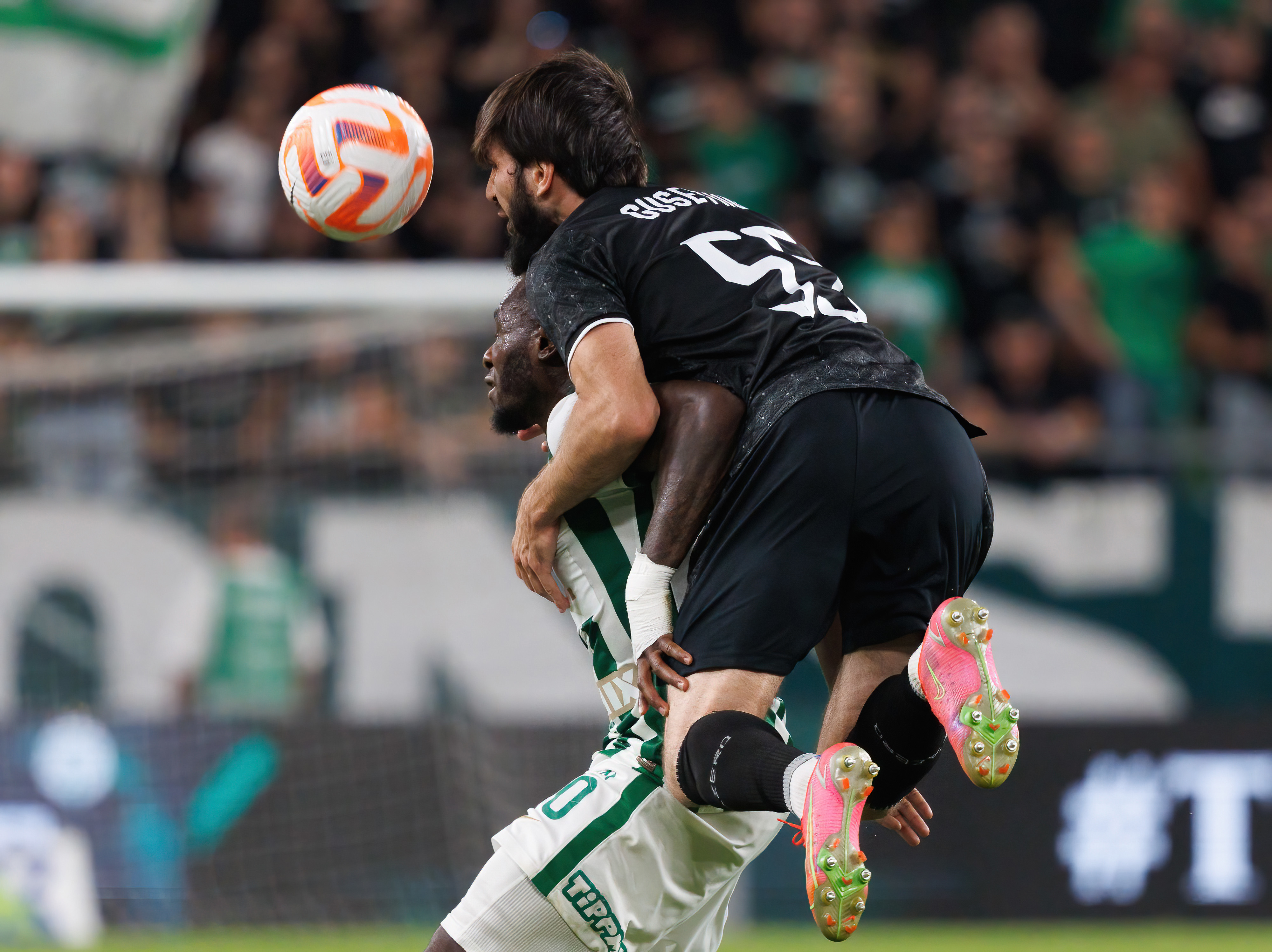 Badavi Huseynov of Qarabag challenges Franck Boli of Ferencvarosi.