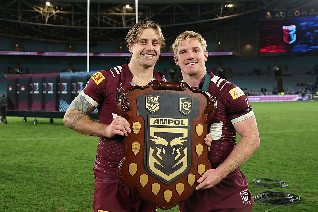 Cameron Munster and Tom Dearden of the Maroons celebrate with the State of Origin Shield.